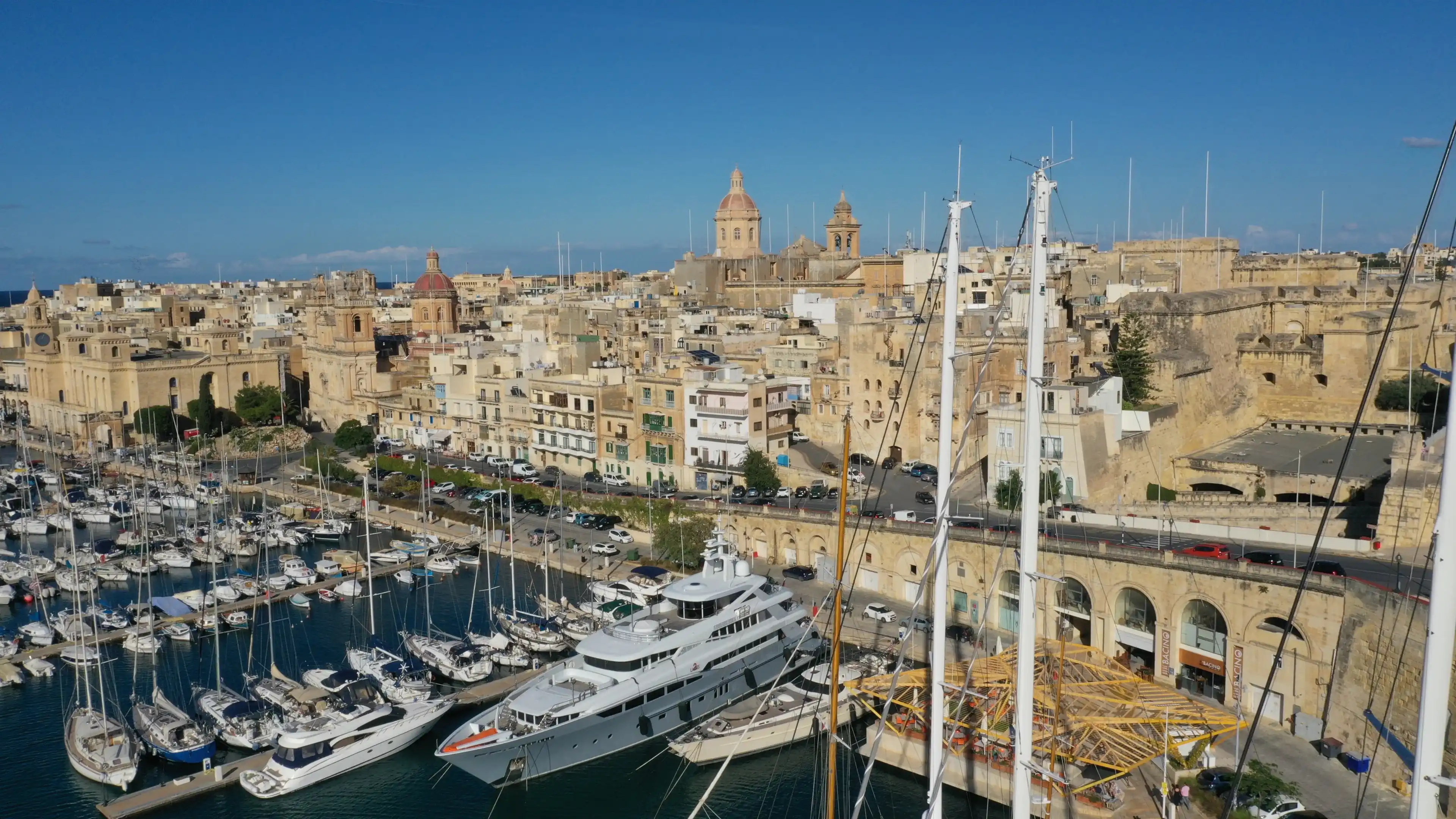 Aerial view of sailboats moored in harbour Senglea, Birgu, Bormla / Cospicua, Valletta, Malta. Ancient architecture of old town: christian orthodox churches, cathedrals, basilicas. Sunny summer travel Aerial view of sailboats moored in harbour Senglea, Birgu, Bormla / Cospicua, Valletta, Malta. Ancient architecture of old town: christian orthodox churches, cathedrals, basilicas. Sunny summer travel