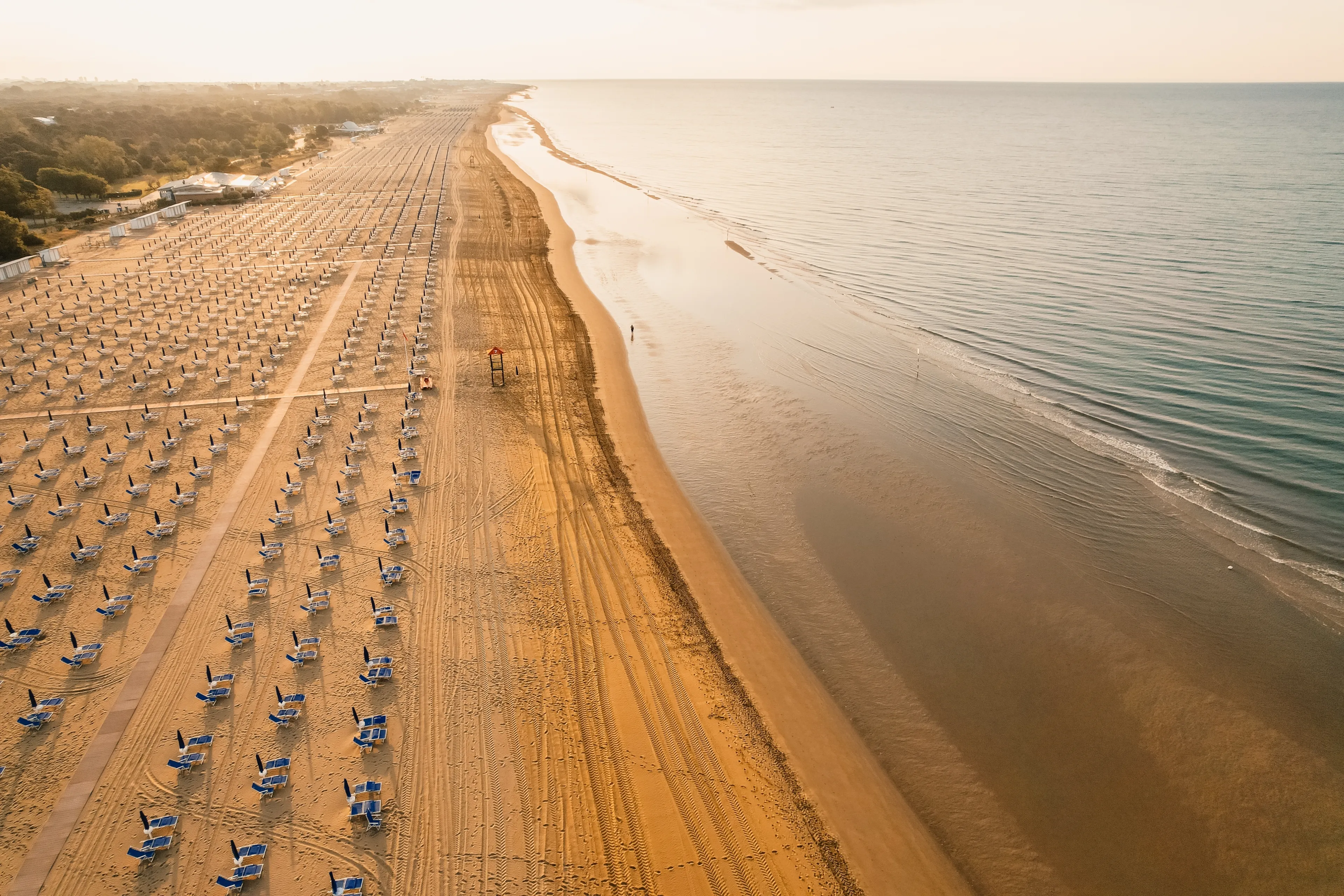 Morning on the still deserted beach. Umbrella beach for relaxing and sun set beach. Bibione, Italy