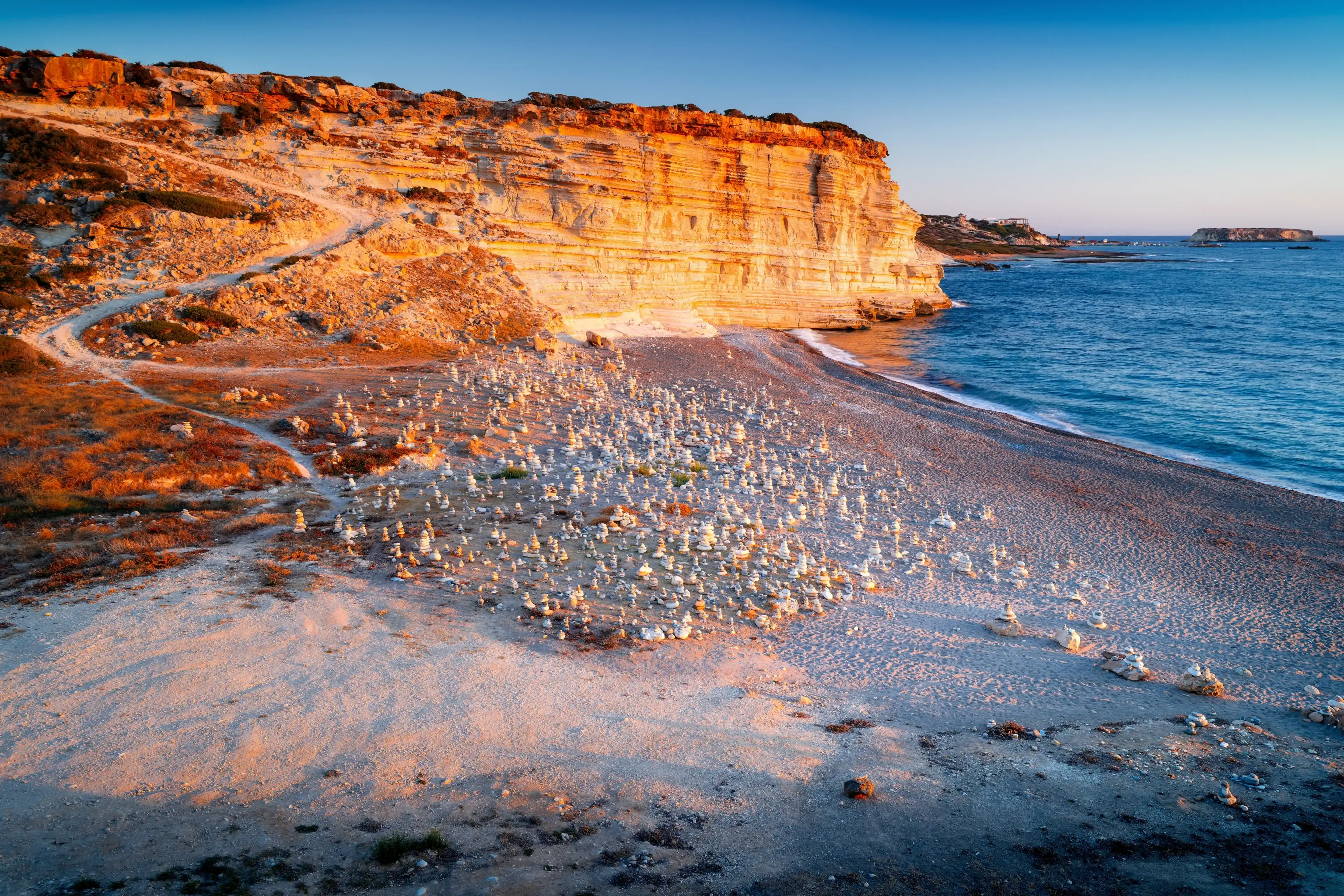The most beautiful beach in Cyprus, nestled in a bay with cliffs at sunset. White River Beach, Mediterranean Sea, Peyia, Cyprus. The most beautiful beach in Cyprus, nestled in a bay with cliffs at sunset. White River Beach, Mediterranean Sea, Peyia, Cyprus.