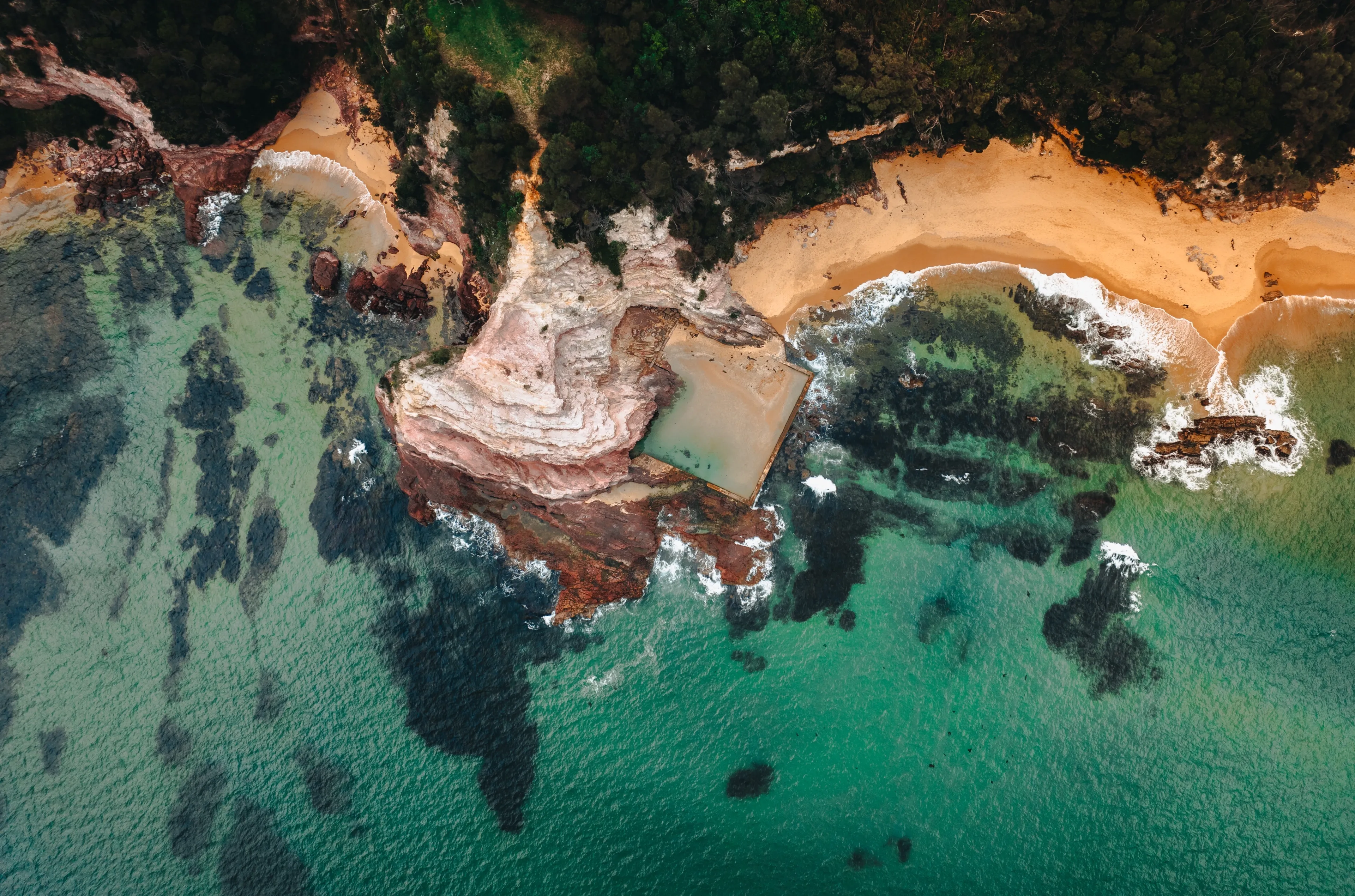 Aerial Drone Shot of Aslings Beach Rock Pool in Eden, New South Wales, Australia.