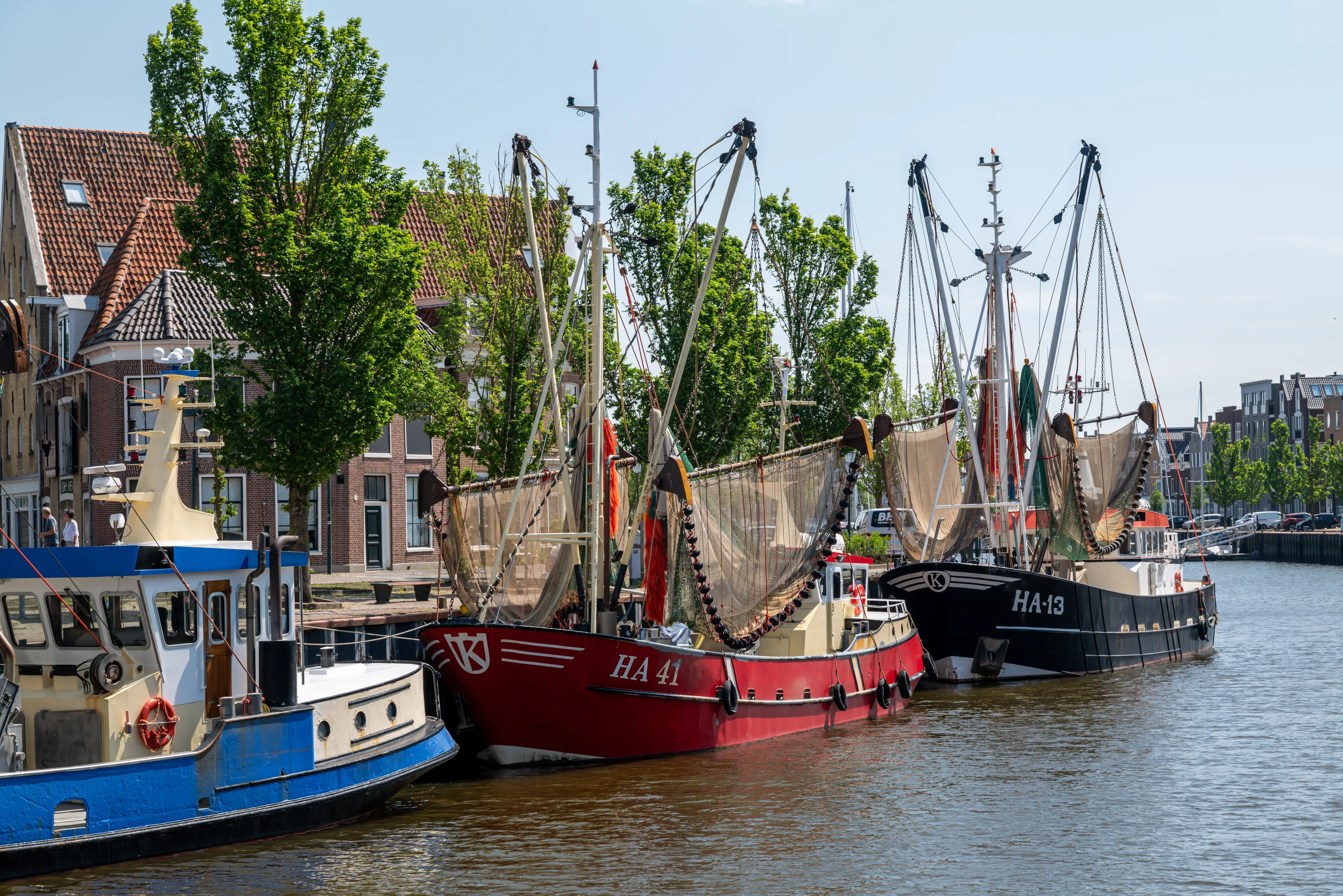 Harlingen, The Netherlands - 2024-05-20: Fishing vessels in the old harbour, with the fishing net drying in the sun