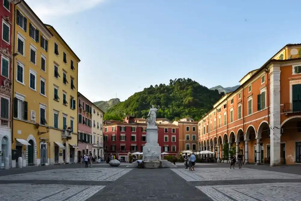 Carrara Italy 04.06.2022: Captivating Carrara: A Glimpse of the Beautiful Central Square with Vibrantly Colored Buildings Carrara Italy 04.06.2022: Captivating Carrara: A Glimpse of the Beautiful Central Square with Vibrantly Colored Buildings