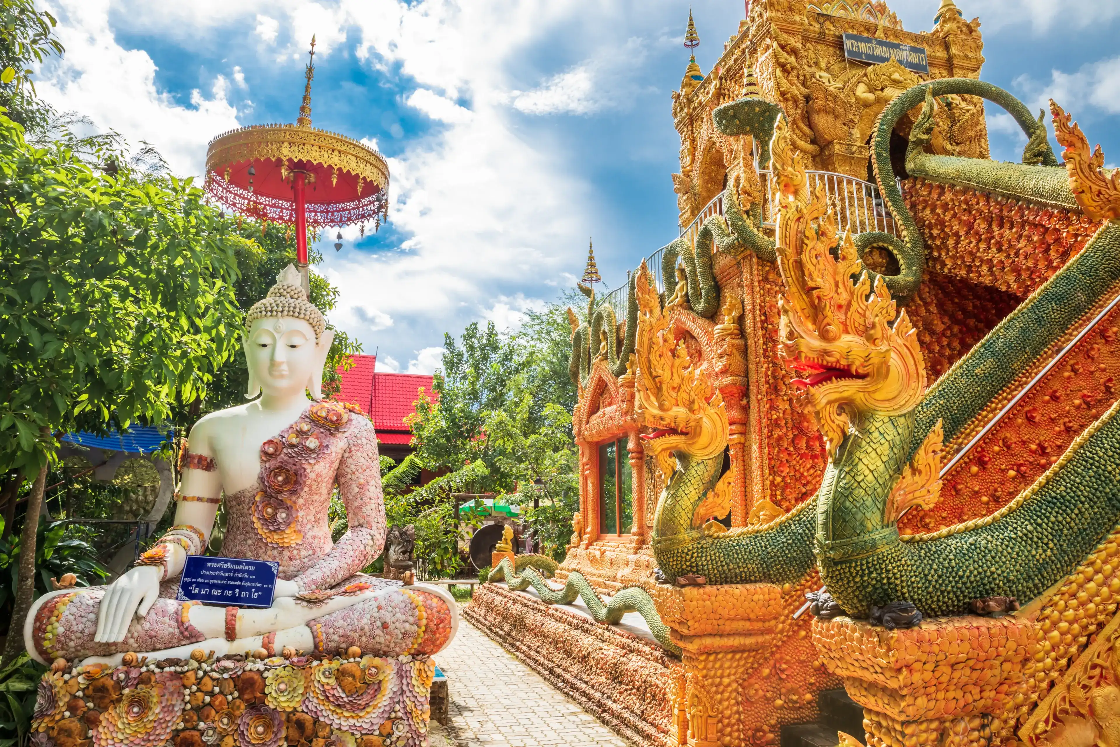 Buddha in sitting decorated with many kinds of shells at the base. The highlight of Rattanet Ta Ram temple,Prachin buri,Thailand Buddha in sitting decorated with many kinds of shells at the base. The highlight of Rattanet Ta Ram temple,Prachin buri,Thailand