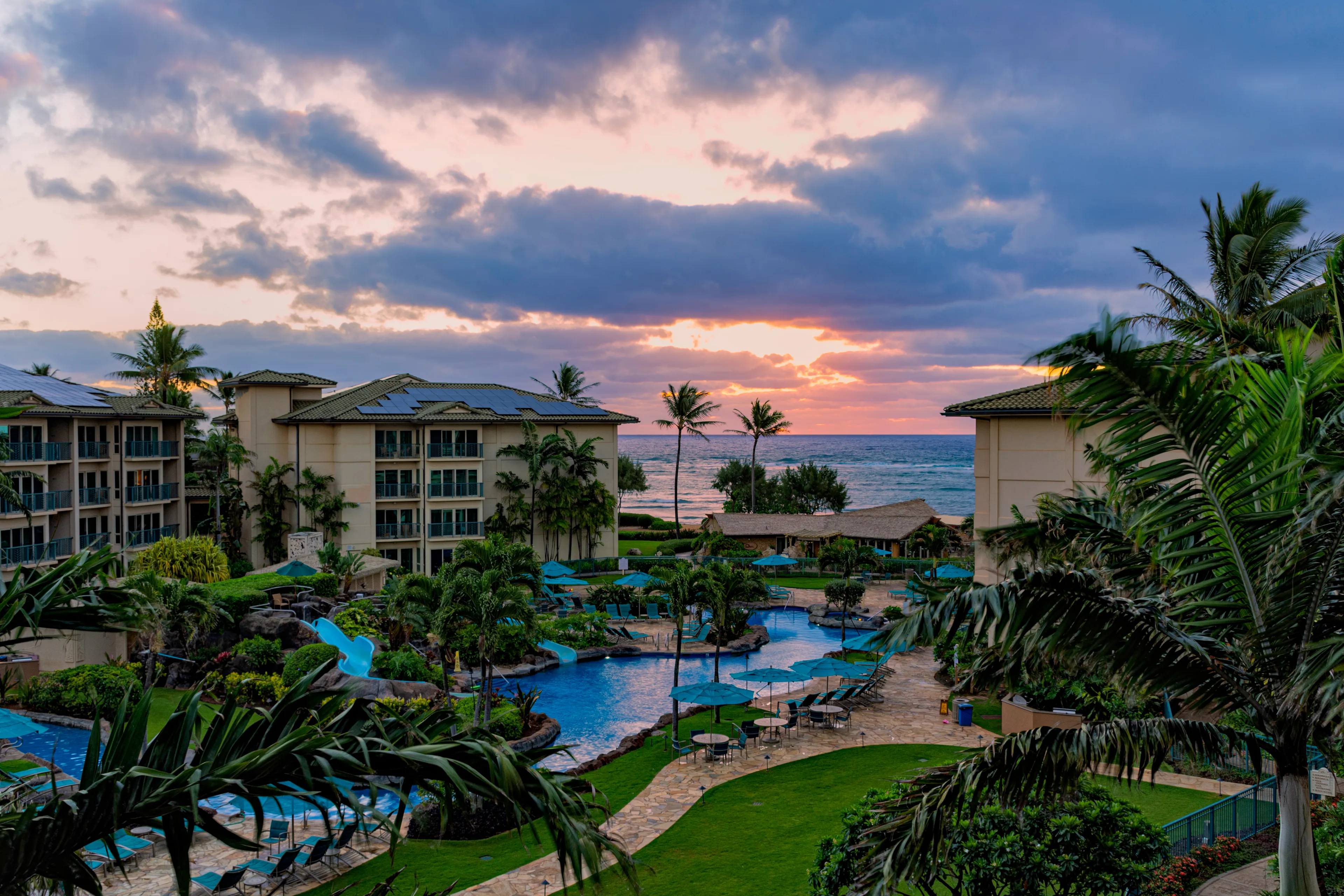 Kapa'a Kauai Hawaii USA - April 18, 2019: Sunrise over the ocean at a resort at Waipouli Beach with pool in the foreground