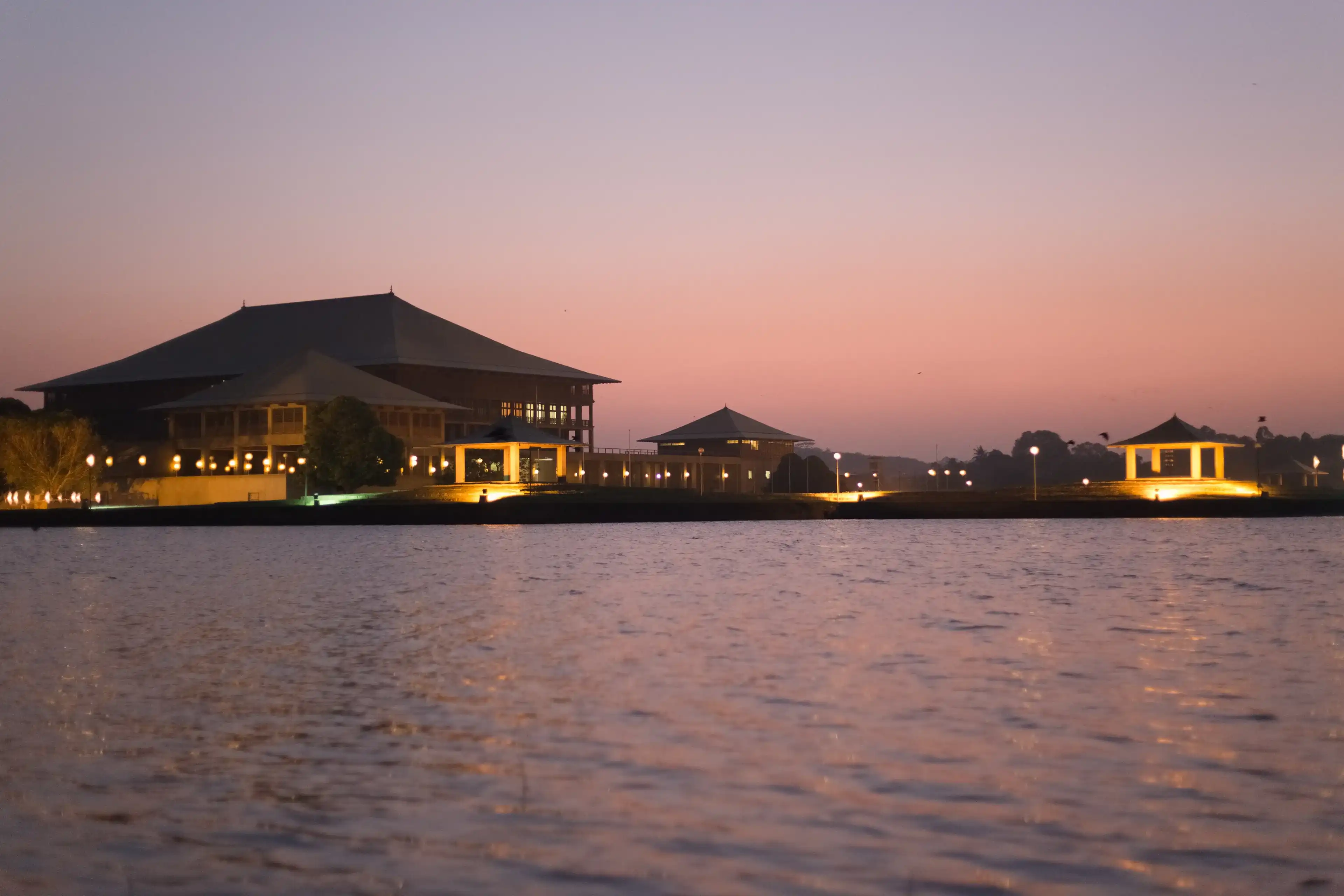 Parliament of Sri Lanka Ceylon, across Diyawanna lake waterscape in clear sunset background in evening night lights on at Colombo. Parliament of Sri Lanka Ceylon, across Diyawanna lake waterscape in clear sunset background in evening night lights on at Colombo.