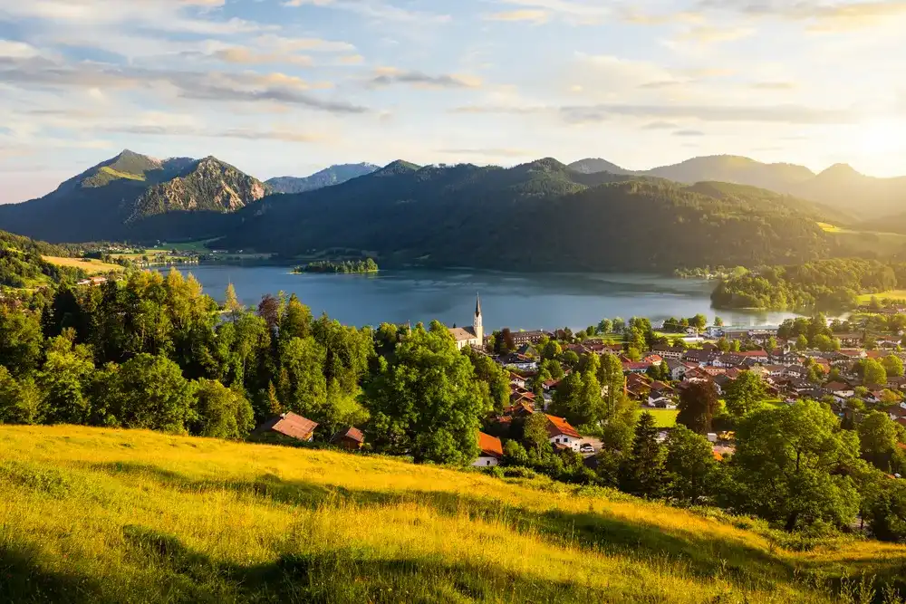 View of mountains and mountain lake during sunset in summer. Beautiful town of Schliersee in Bavaria, Germany, Europe. View of mountains and mountain lake during sunset in summer. Beautiful town of Schliersee in Bavaria, Germany, Europe.