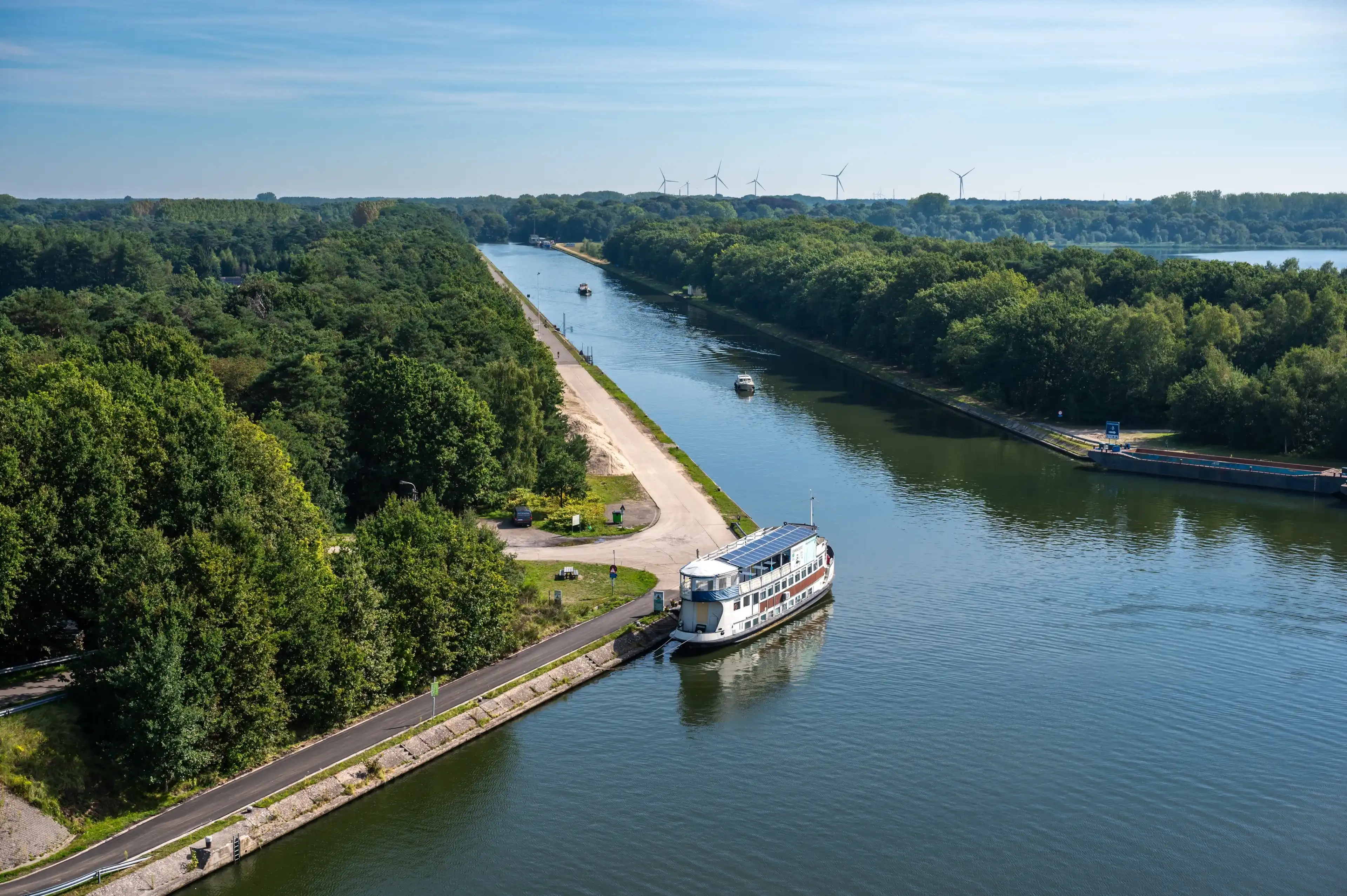 Dessel, Antwerp Province, Belgium, September 7, 2023 - Tower view over the woods and the canal with a ship Dessel, Antwerp Province, Belgium, September 7, 2023 - Tower view over the woods and the canal with a ship