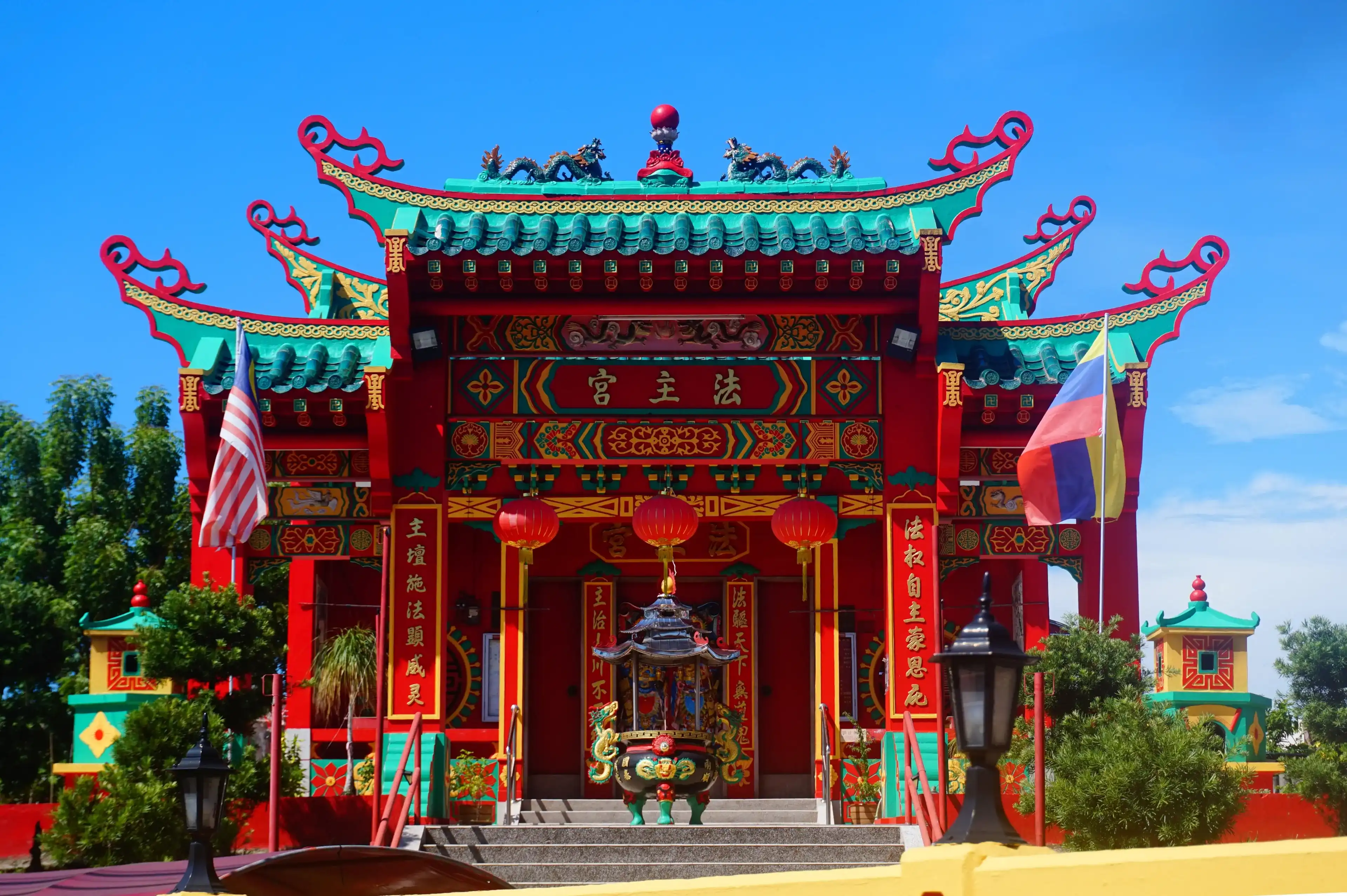 Labuan, Malaysia - April 23, 2024: The front entrance of the Huat Choo Kung Temple is located at Jalan Tun Mustapha Labuan Malaysia. A Red temple named Huat Choo Kung in Malaysia territory. Labuan, Malaysia - April 23, 2024: The front entrance of the Huat Choo Kung Temple is located at Jalan Tun Mustapha Labuan Malaysia. A Red temple named Huat Choo Kung in Malaysia territory.
