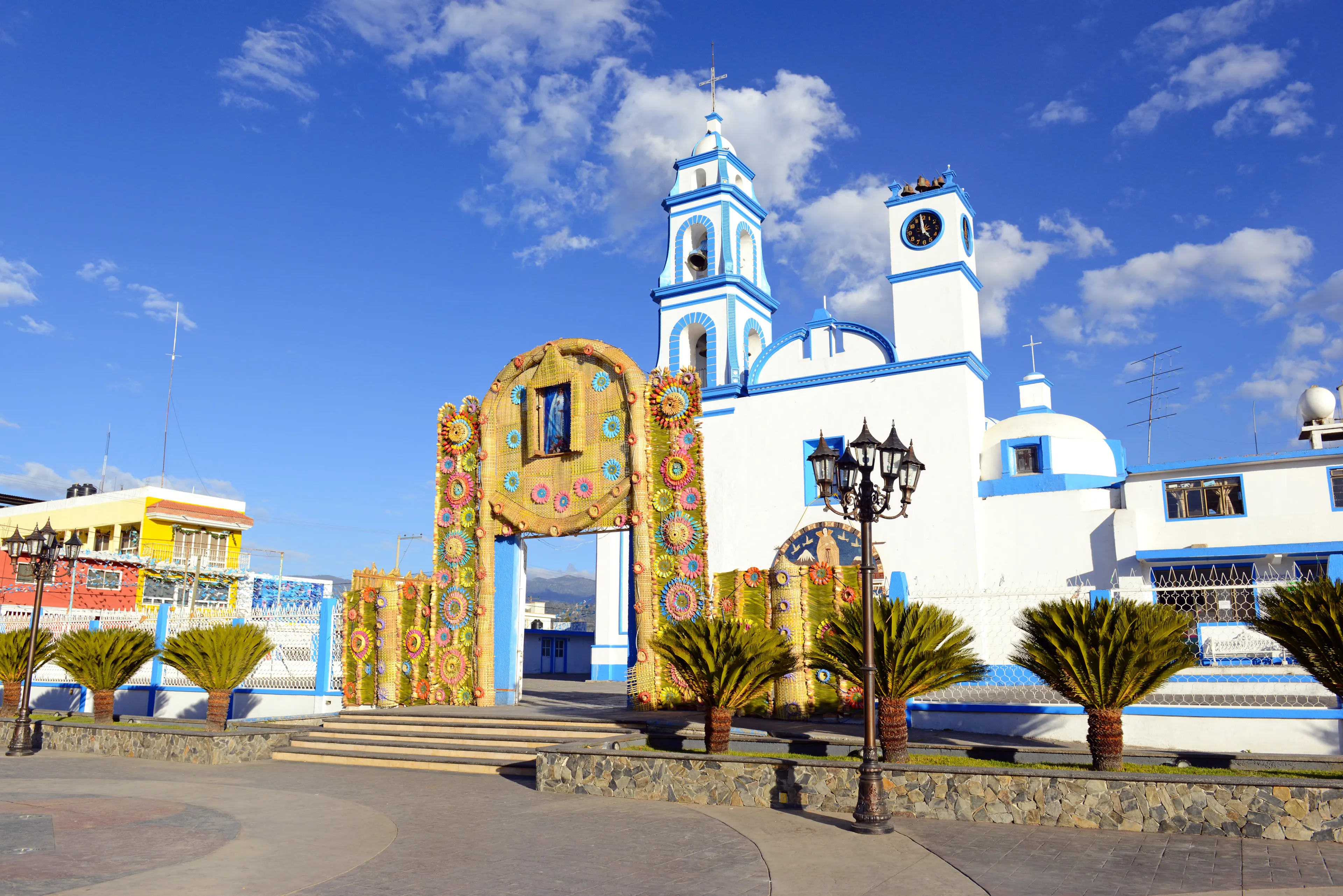 Colorful Church with blue sky background located near borders of Veracruz and Puebla, close to Pico de Orizaba, Iztaccihuatland Popocatepetl volcanoes, Mexico