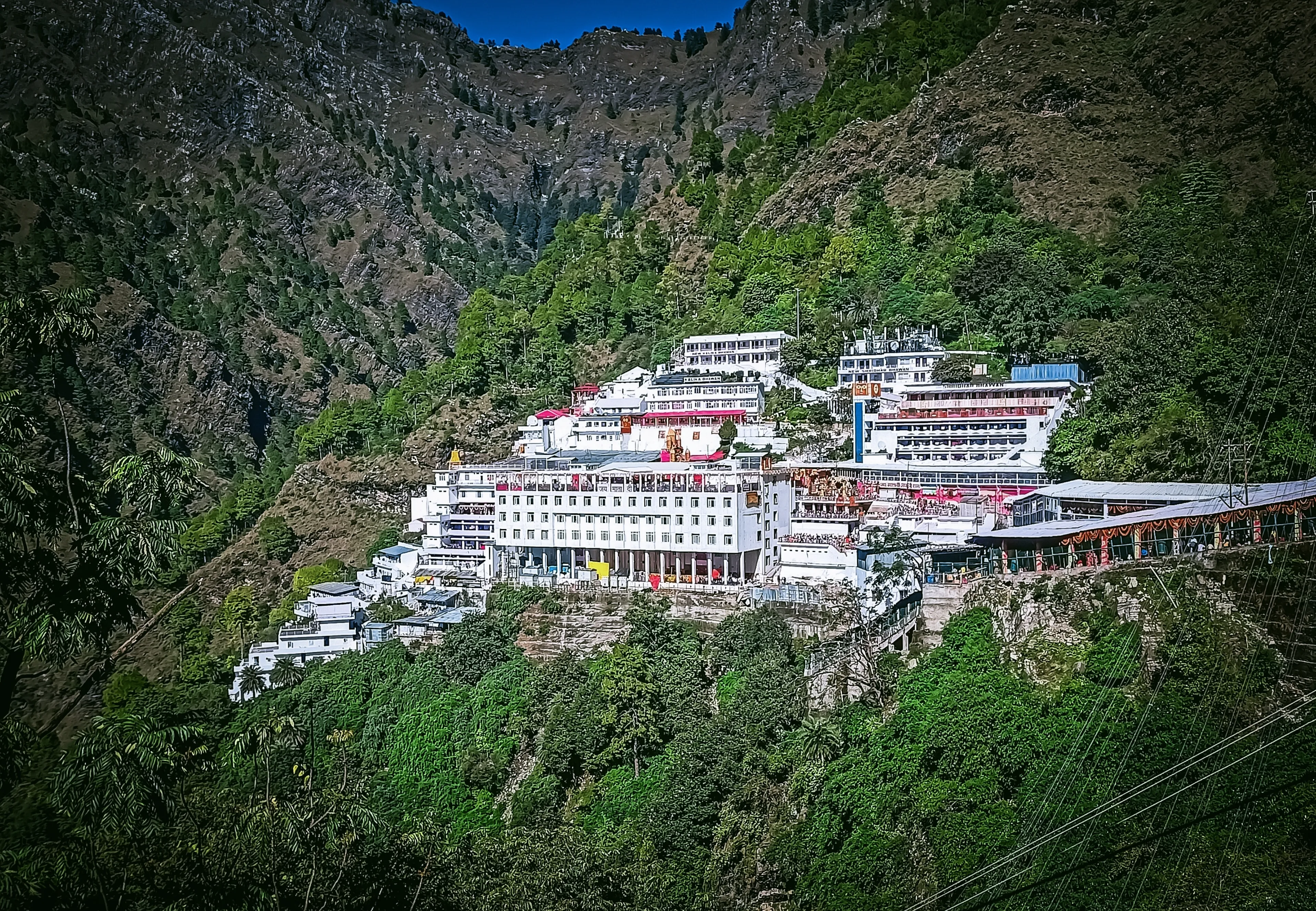 Wonderful View Of Mata Vaishno Devi Bhawan Is Located In Katra (Jammu and Kashmir) Holy White Bhawan Covered By Mountains And Trees.