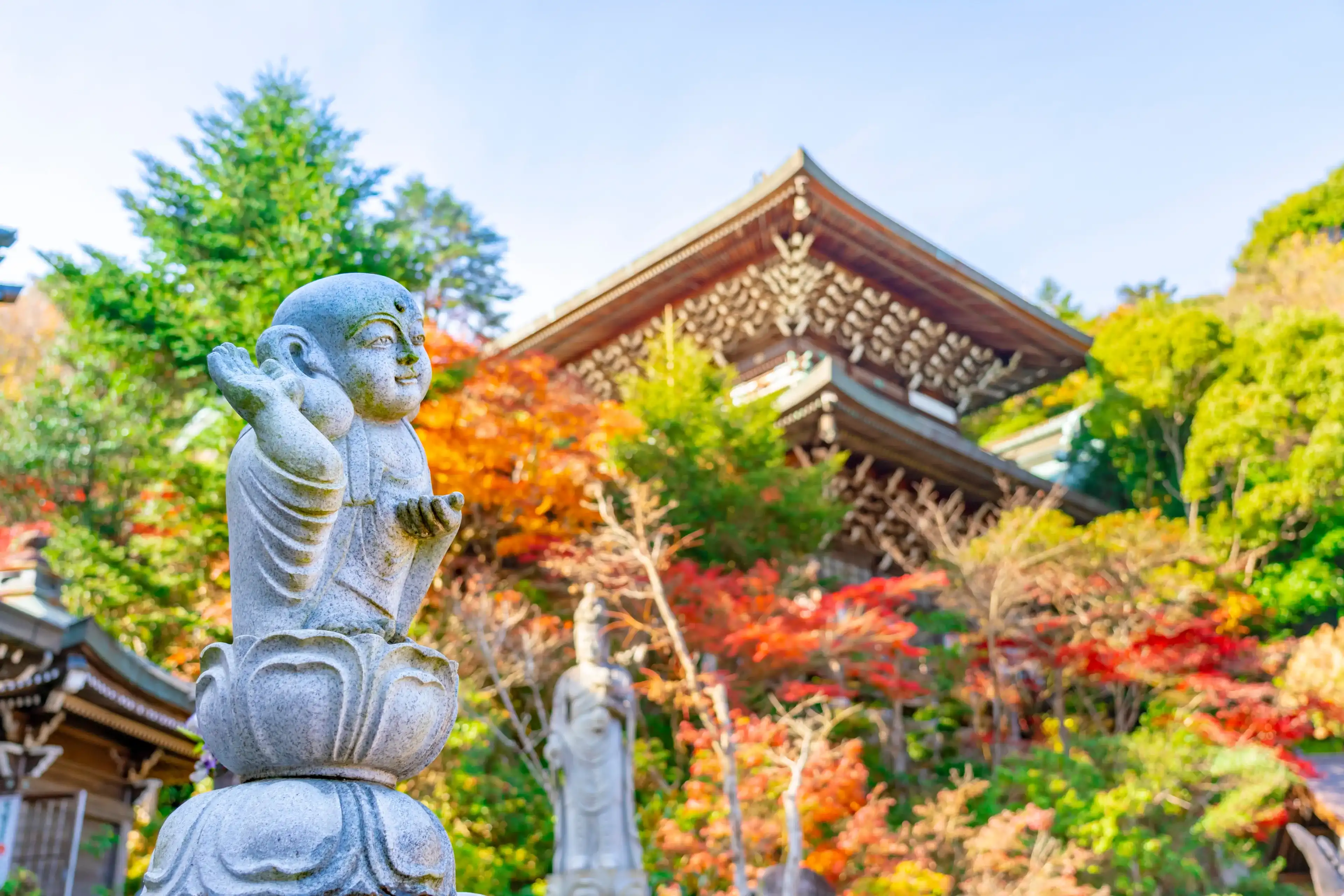 Buddha sculpture in Daishō-in, next to Itsukushima Shrine temple, in front of floating gate, or torii. The complex is listed as a UNESCO World Heritage Site. Miyajima, Hiroshima, Japan. Buddha sculpture in Daishō-in, next to Itsukushima Shrine temple, in front of floating gate, or torii. The complex is listed as a UNESCO World Heritage Site. Miyajima, Hiroshima, Japan.