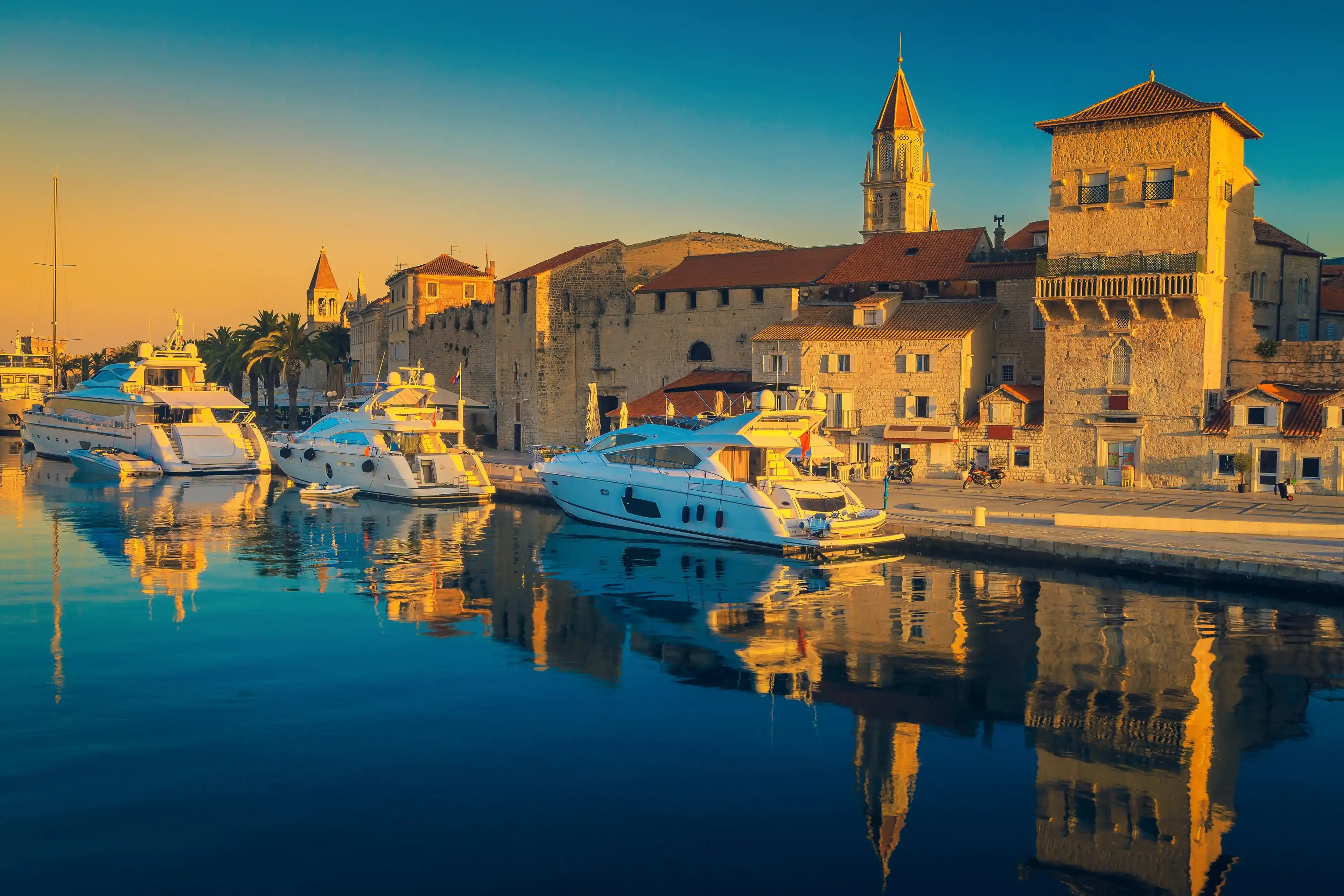 Admirable promenade in the touristic harbor with yachts, boats and spectacular medieval buildings, Trogir old town, Dalmatia, Croatia, Europe Admirable promenade in the touristic harbor with yachts, boats and spectacular medieval buildings, Trogir old town, Dalmatia, Croatia, Europe