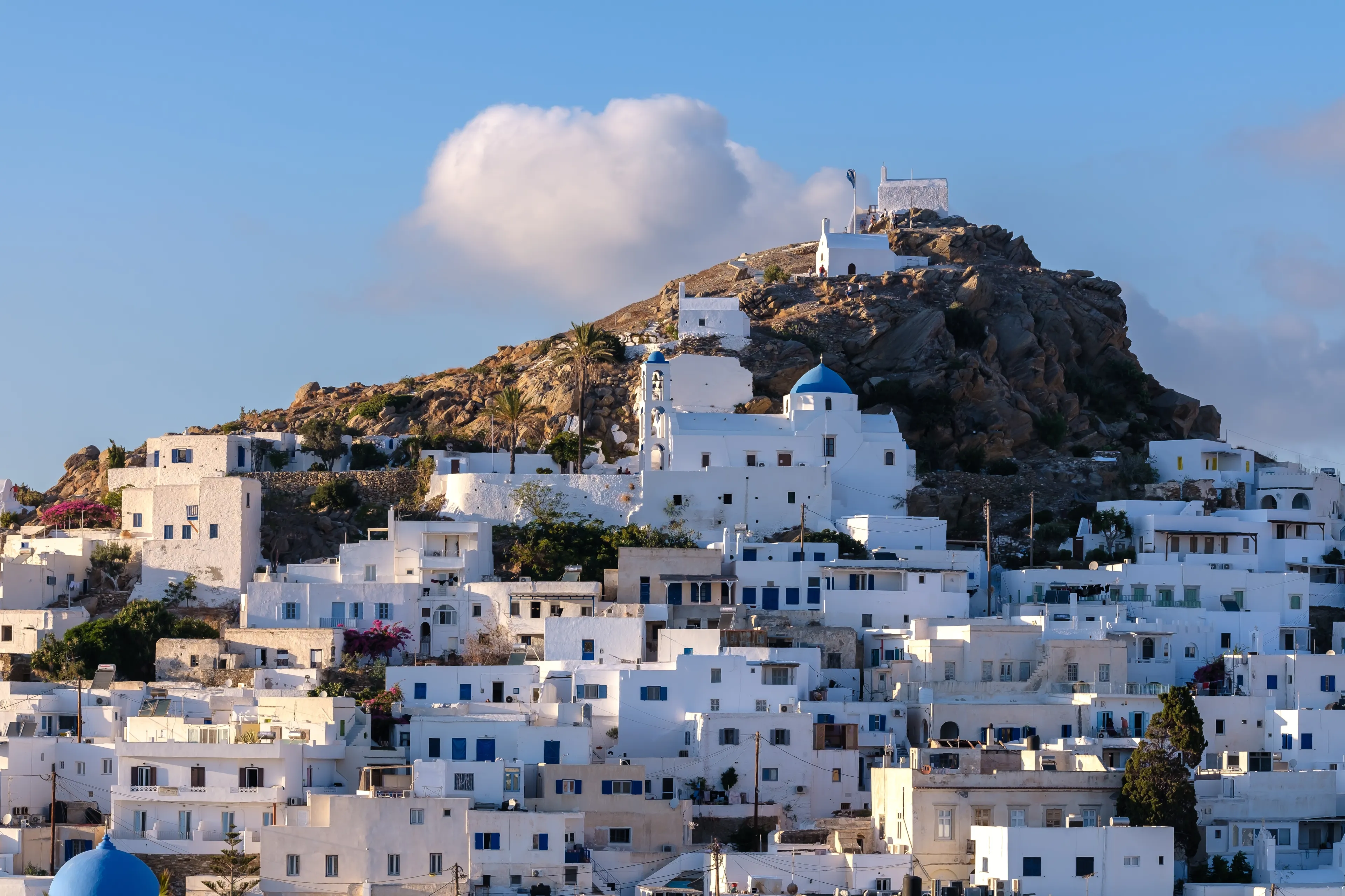 Panoramic view of the picturesque and whitewashed island of Ios Greece and a blue sky in the background