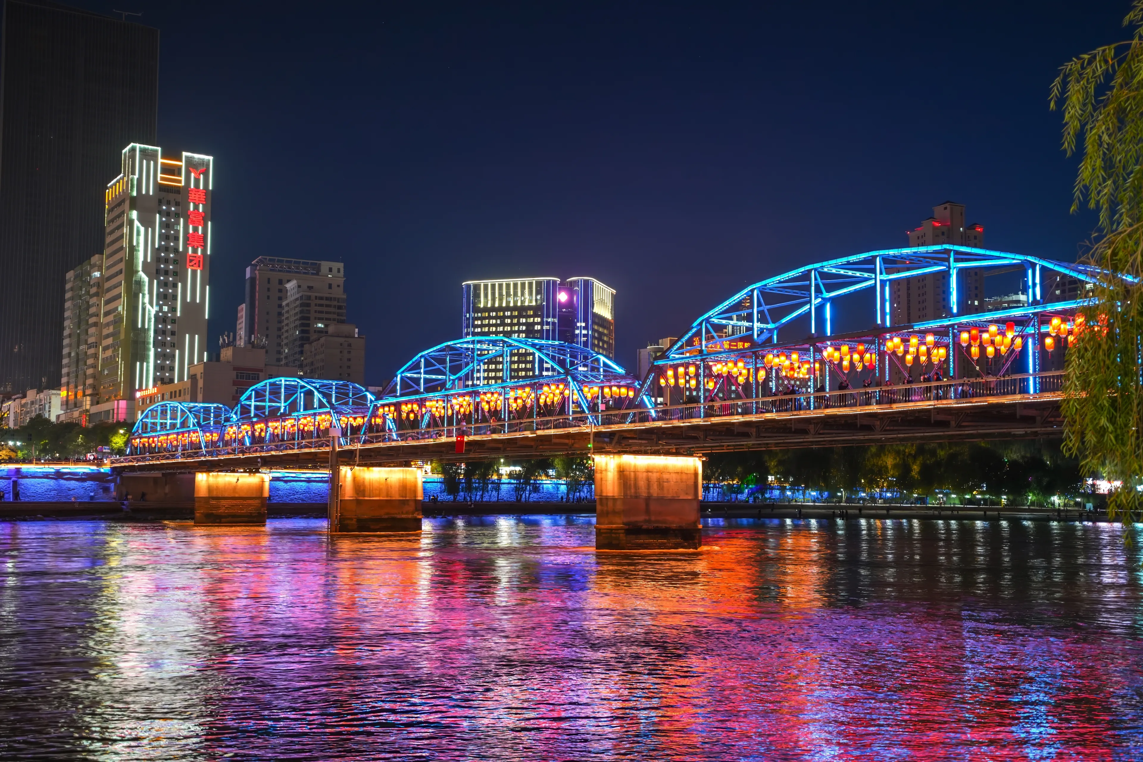 LANZHOU, CHINA- OCT 16, 2024- The city view with Zhongshan bridge and yellow river in Gansu province, Lanzhou city. The must landmark to visit of tourists.
