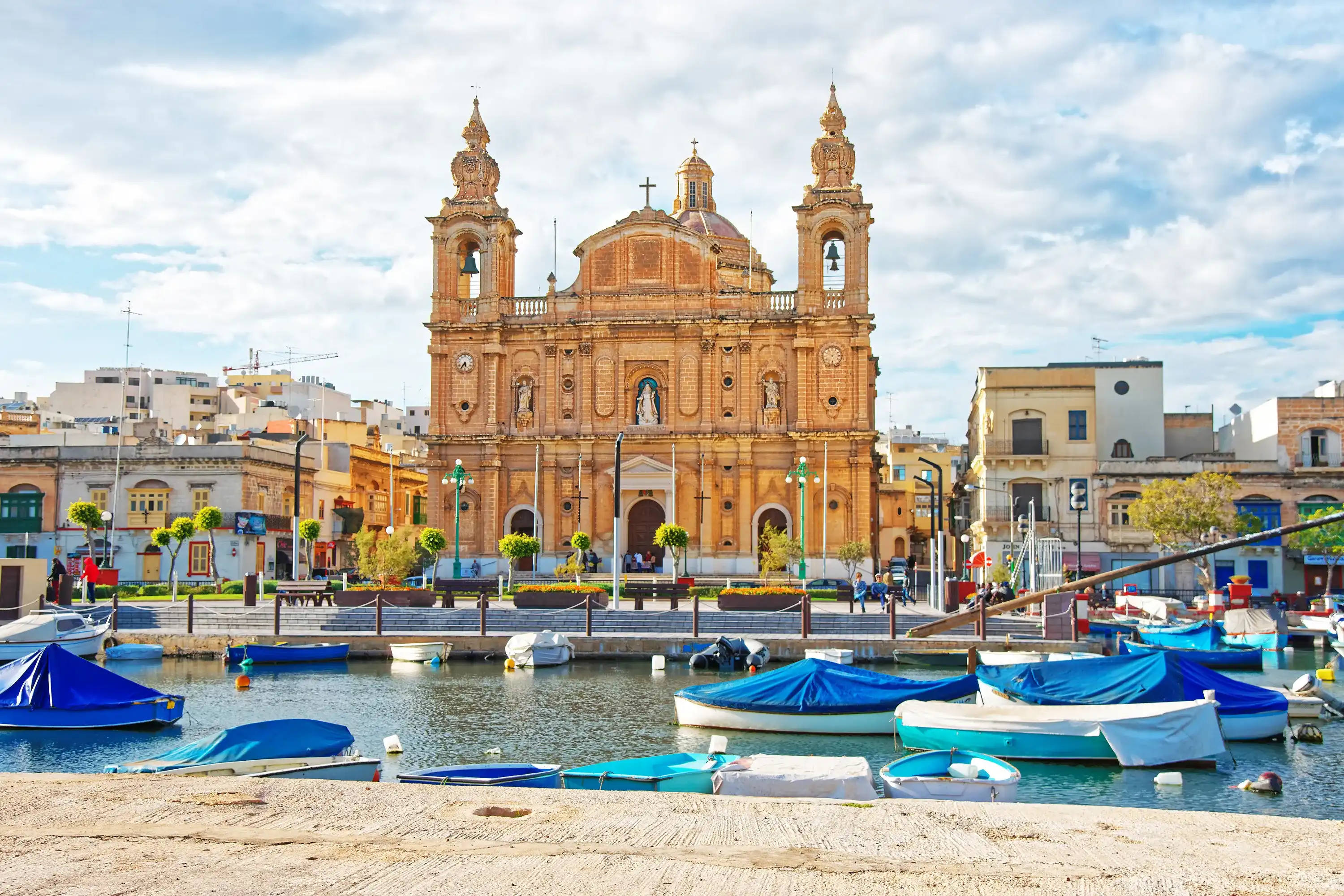 Parish Church at Msida marina with boats on Malta Island. People on the background Parish Church at Msida marina with boats on Malta Island. People on the background