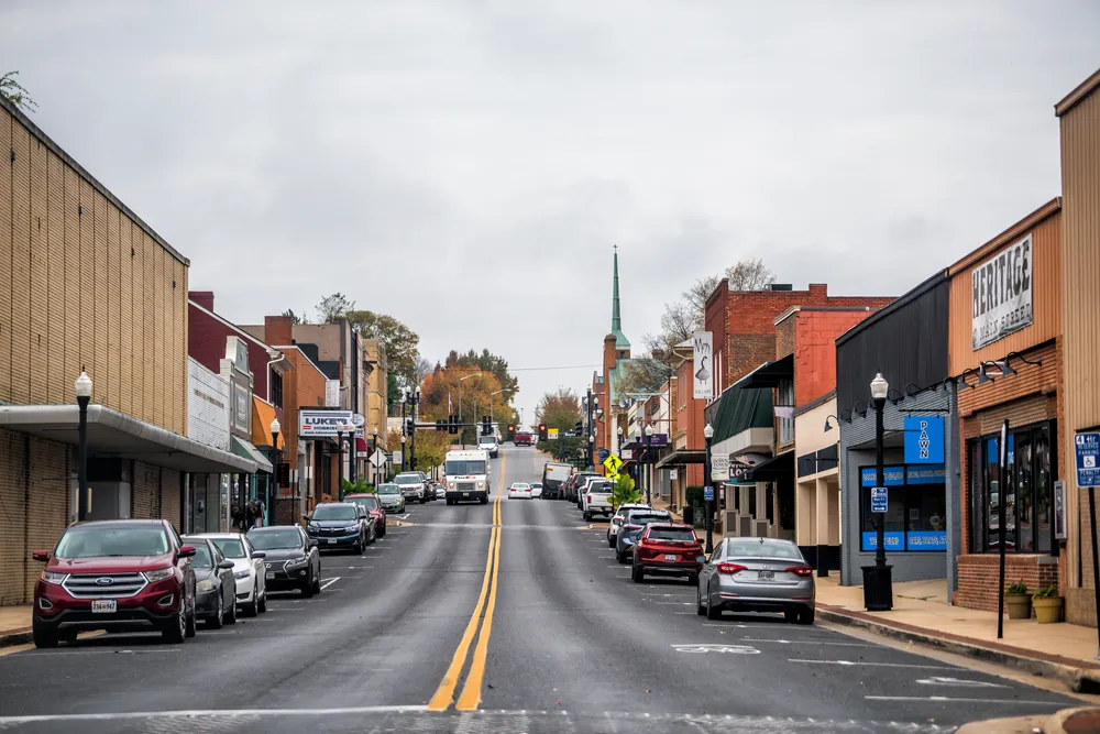Waynesboro, USA - October 27, 2020: Downtown in small town city with Main street in rural Virginia and cars parked by stores shops building on cloudy day