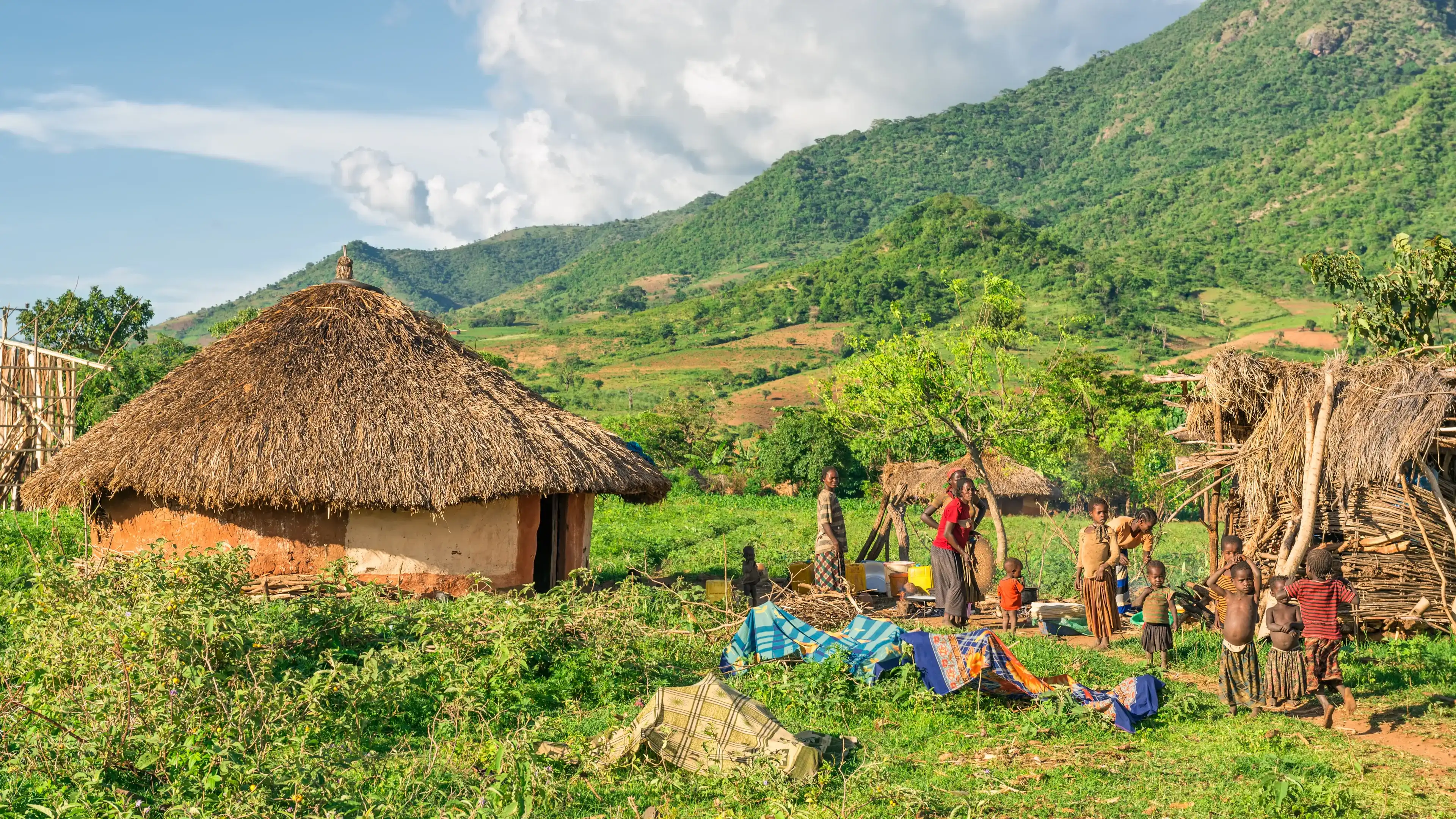 OMO VALLEY, ETHIOPIA - MAY 6, 2015 : Ethiopian family preparing dinner in front of their home in the southern part of Ethiopia. OMO VALLEY, ETHIOPIA - MAY 6, 2015 : Ethiopian family preparing dinner in front of their home in the southern part of Ethiopia.
