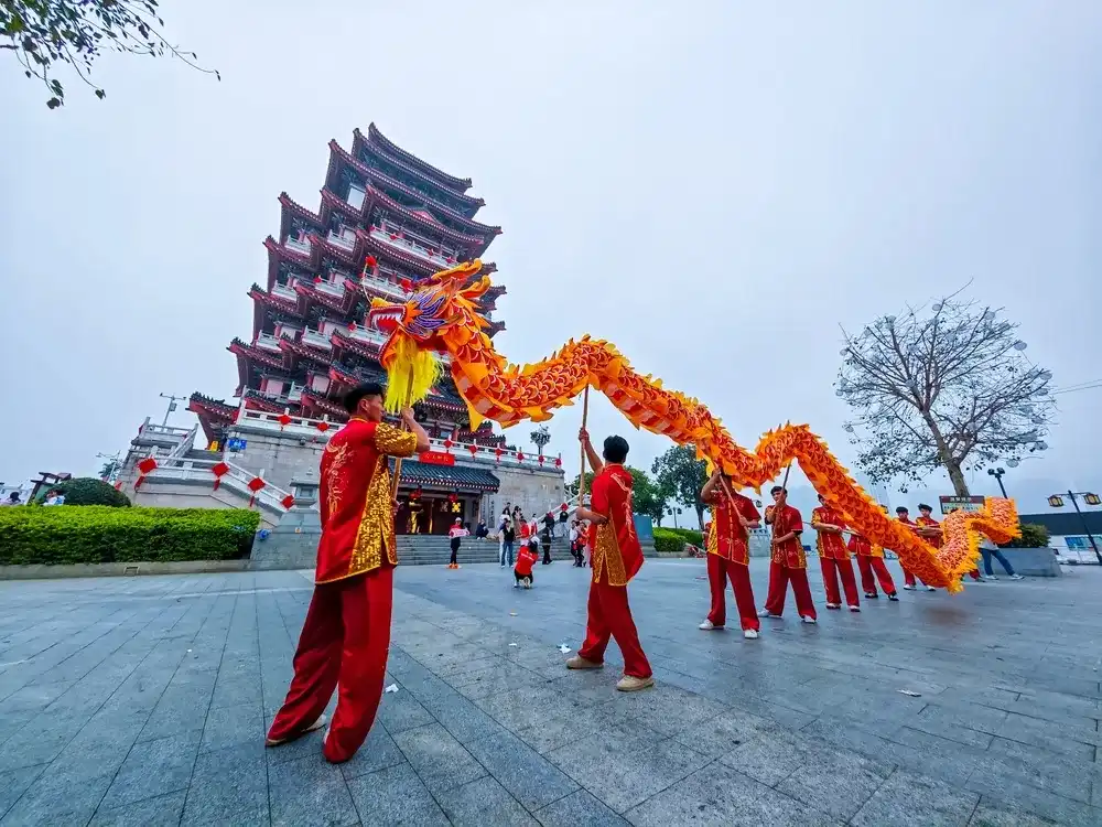 Huizhou, China - Mar 17, 2024: For Huizhou Marathon, Huizhou City Cultural Center organized a dragon dance team to perform in front of Hejiang Pavilion Huizhou, China - Mar 17, 2024: For Huizhou Marathon, Huizhou City Cultural Center organized a dragon dance team to perform in front of Hejiang Pavilion