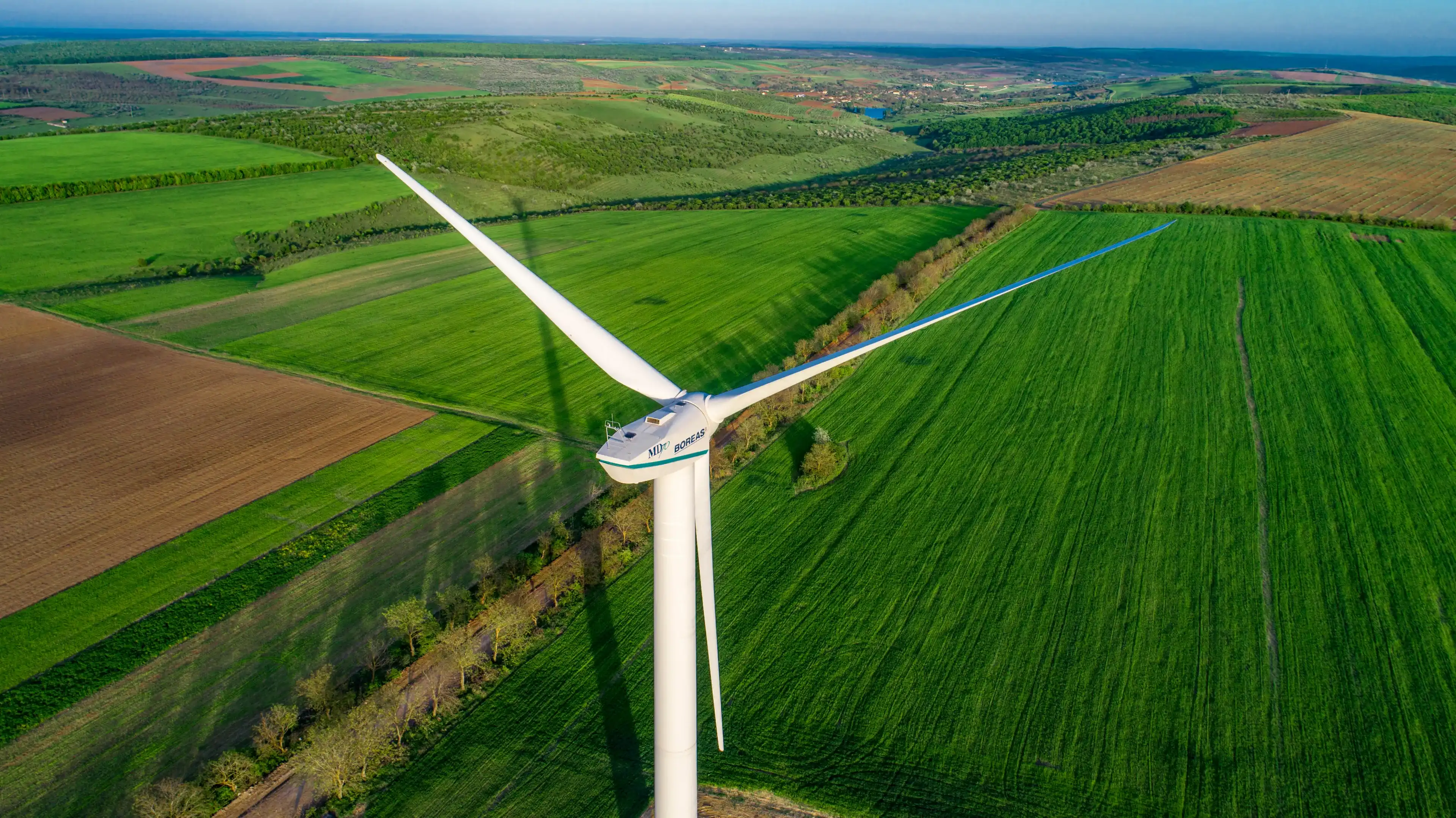 Busauca, Rezina / Moldova - april 30 2018: Boreas MD 70 wind turbine in green fields shot with a drone Busauca, Rezina / Moldova - april 30 2018: Boreas MD 70 wind turbine in green fields shot with a drone