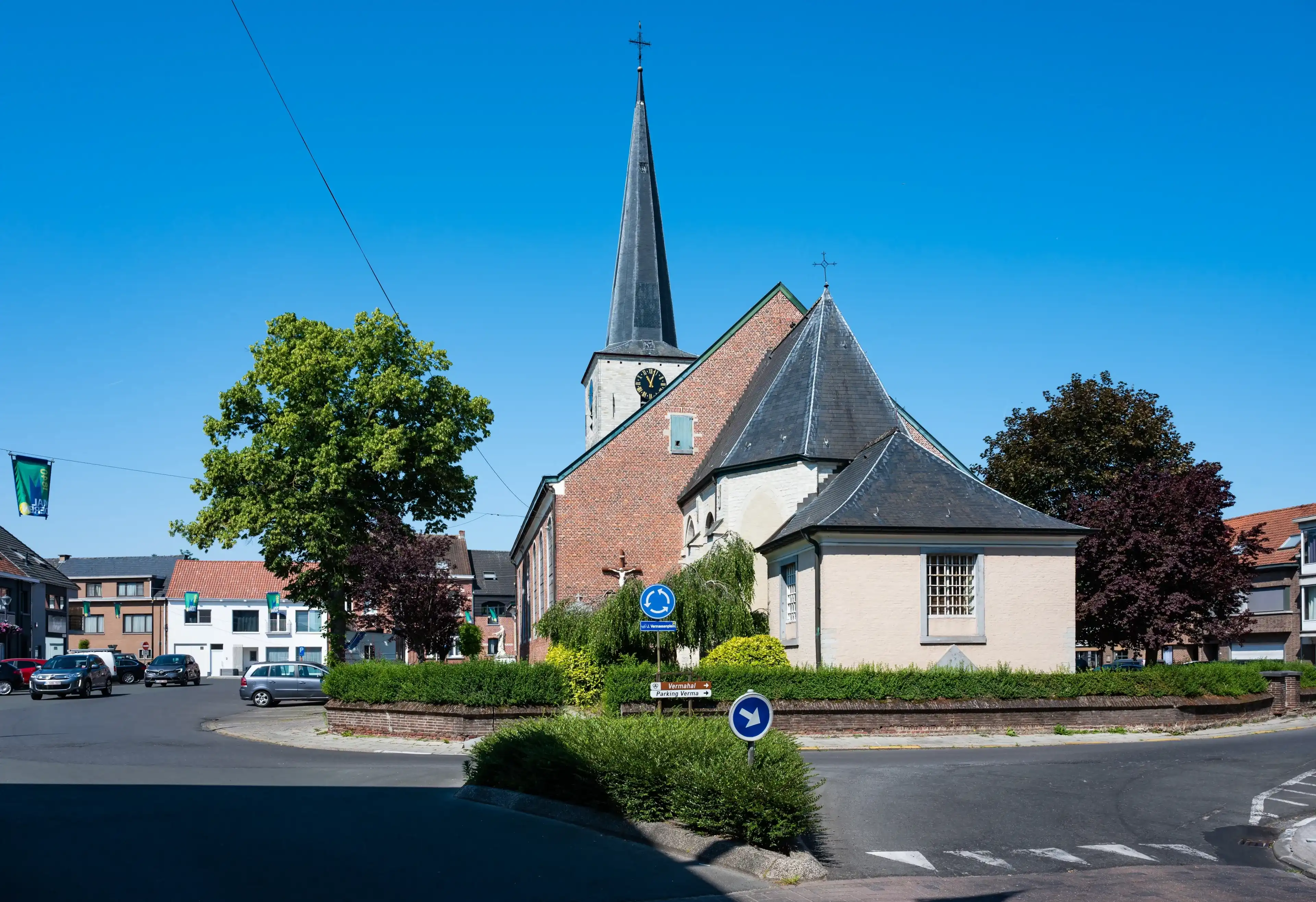 Buggenhout, East Flemish Region, Belgium, June 11, 2023 - Village roundabout and catholic church Buggenhout, East Flemish Region, Belgium, June 11, 2023 - Village roundabout and catholic church