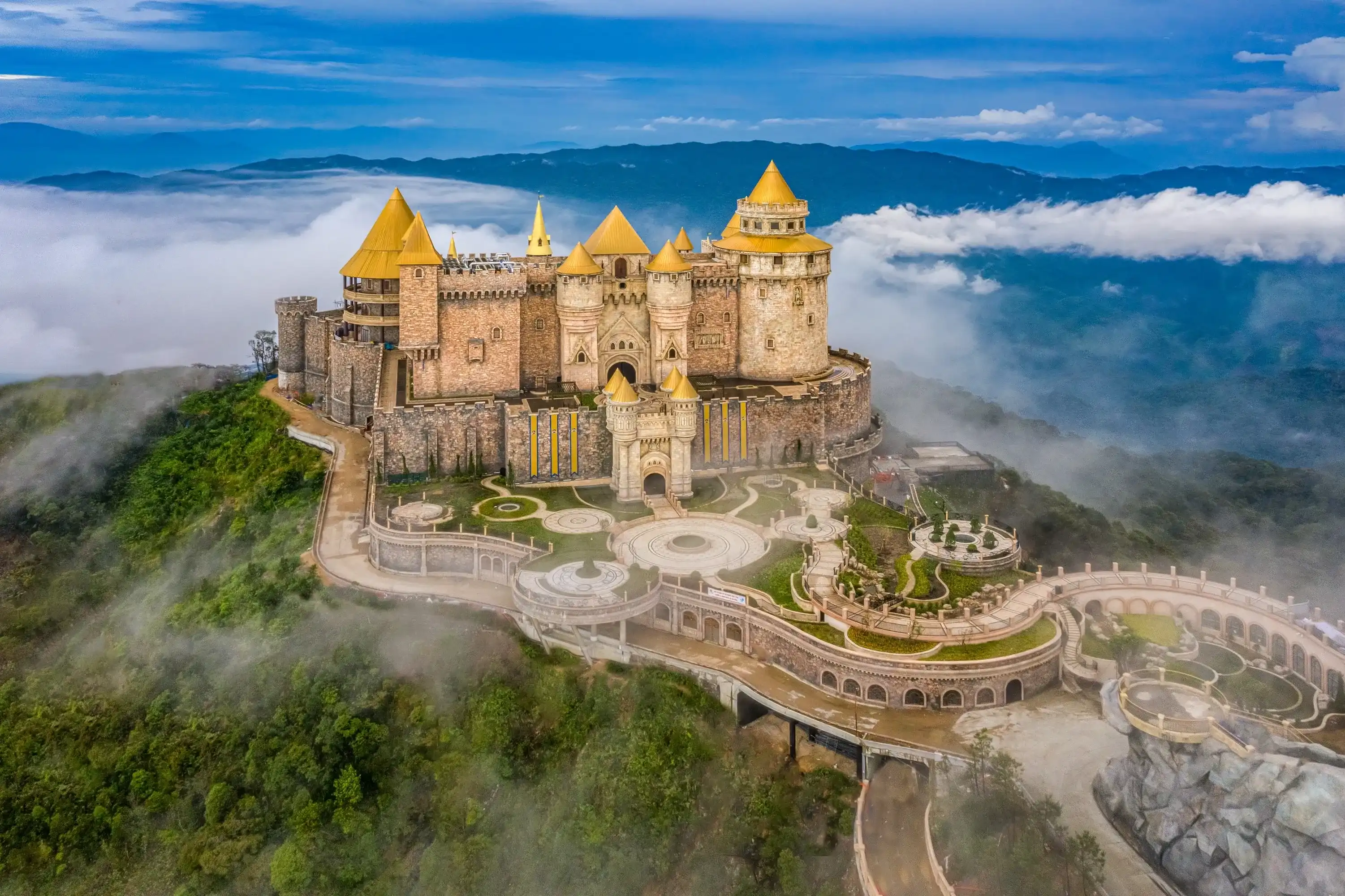 Aerial view of landscape is lunar castles covered with fog at the top of Bana Hills, the famous tourist destination of Da Nang, Vietnam. Near Golden bridge. Panorama Aerial view of landscape is lunar castles covered with fog at the top of Bana Hills, the famous tourist destination of Da Nang, Vietnam. Near Golden bridge. Panorama