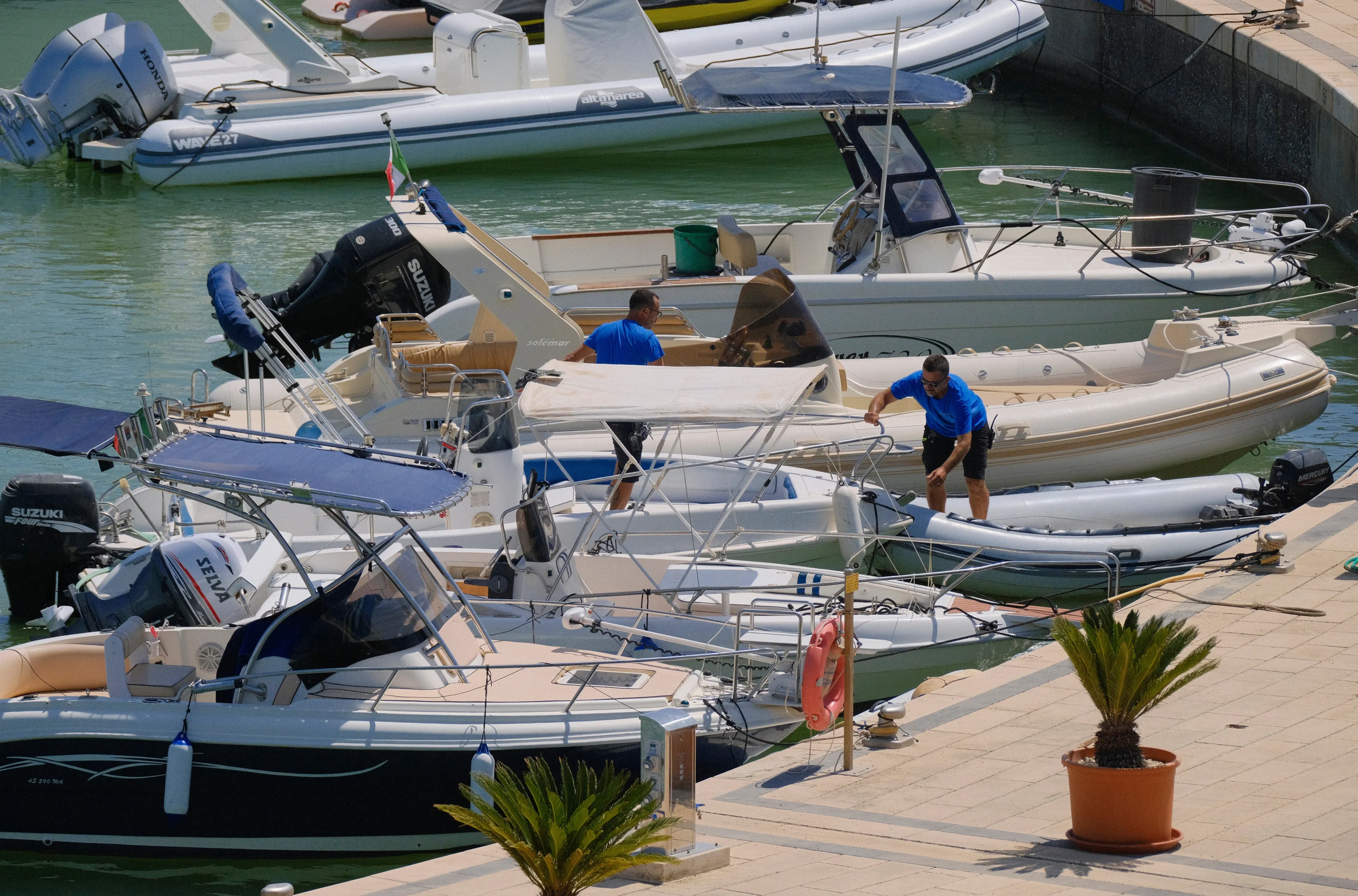 Italy, Sicily, Mediterranean sea, Marina di Ragusa (Ragusa Province); 25 July 2024, people and motor boats in the port - EDITORIAL
