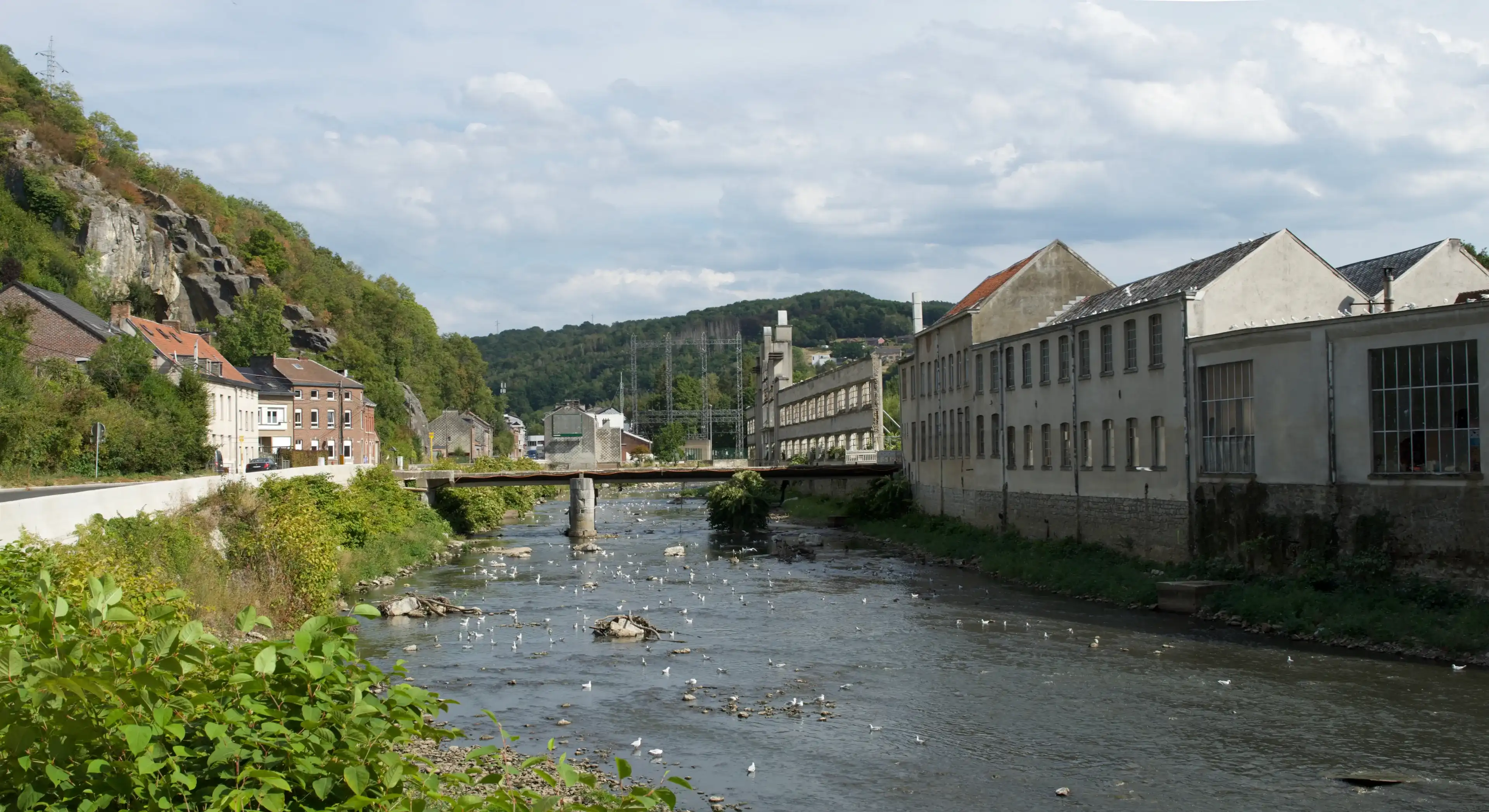 Pepinster, Province of Liège, Belgium - August, 30, 2022: La textile de Pepinster industrial heritage site, along the Vesdre river, has a more unstable outdoor surrounding garden wall after flood Pepinster, Province of Liège, Belgium - August, 30, 2022: La textile de Pepinster industrial heritage site, along the Vesdre river, has a more unstable outdoor surrounding garden wall after flood