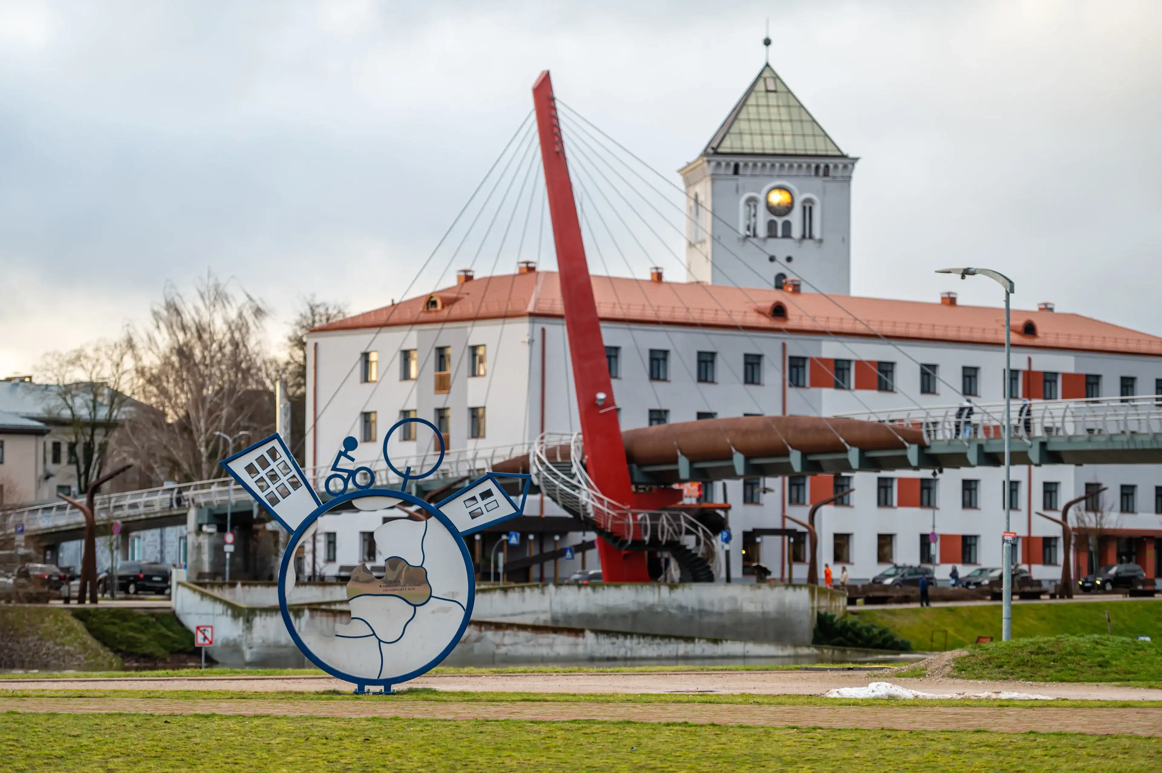 Jelgava, Latvia - January. 14. 2023: View from the Post Island Promenade of the city and pedestrian cable-stayed bridge. Jelgava, Latvia - January. 14. 2023: View from the Post Island Promenade of the city and pedestrian cable-stayed bridge.