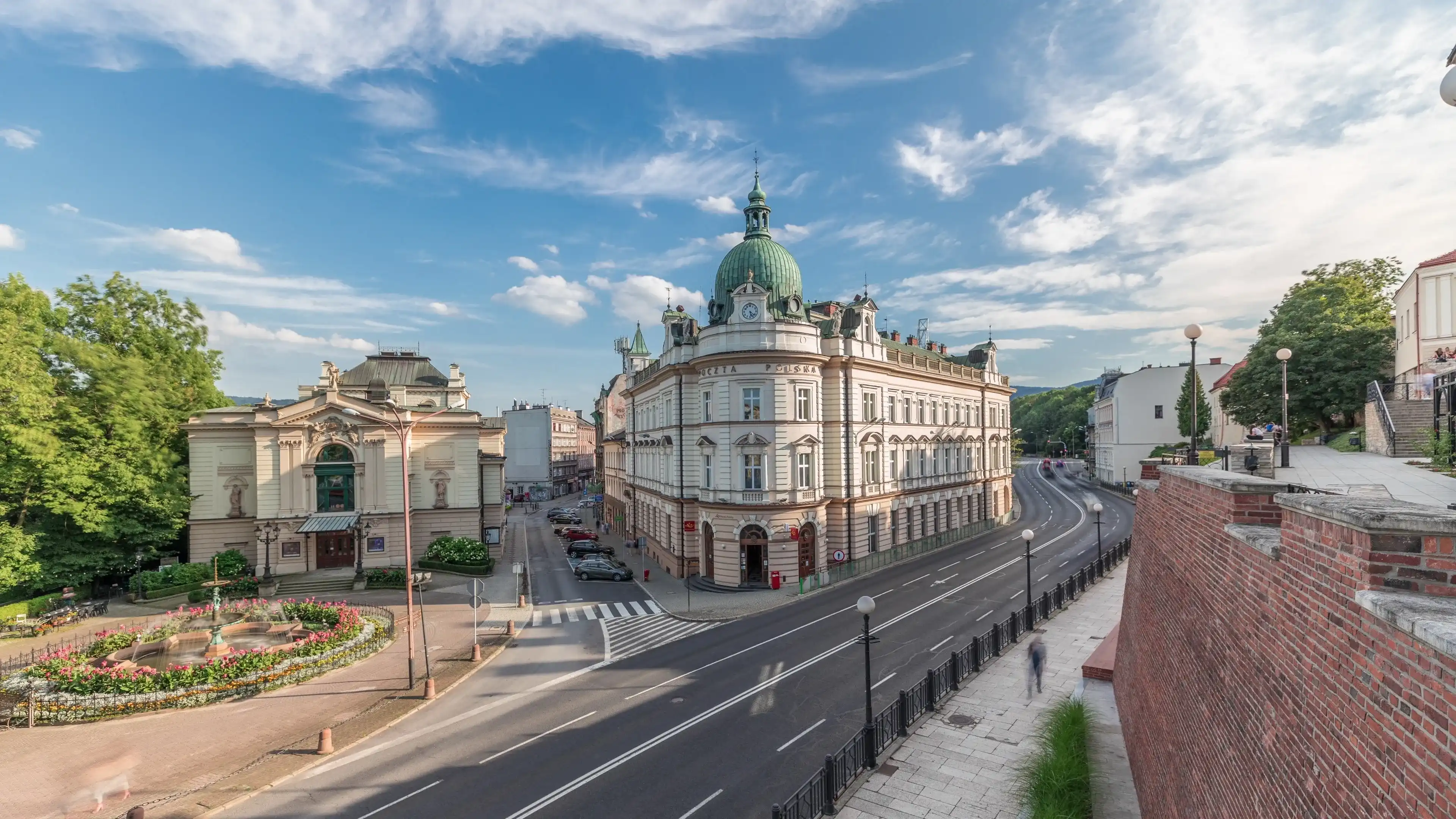 Panorama showing Theater Square with Main Post Office building aerial timelapse and Polish Theater, both built in 1890s, view from the Castle hill. Traffic on the street. Bielsko-Biala, Poland Panorama showing Theater Square with Main Post Office building aerial timelapse and Polish Theater, both built in 1890s, view from the Castle hill. Traffic on the street. Bielsko-Biala, Poland