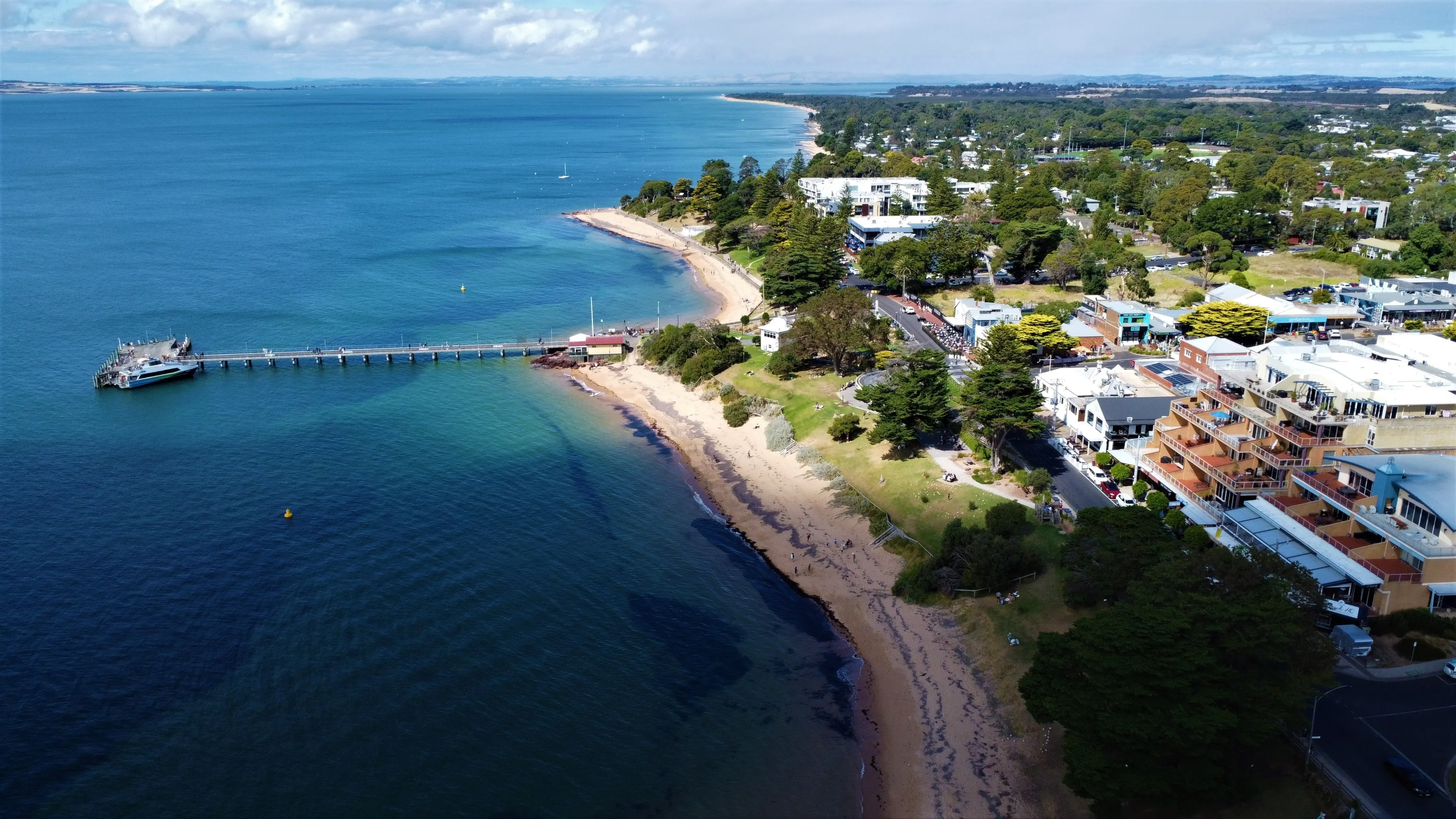 Cowes Foreshore at Phillip Island, Victoria, Australia. Beach Life. Public Space. Rural and Coastal. Main Street with Shops and Jetty. Beachside Apartments. Waterfront Parks and Shopping Precinct.