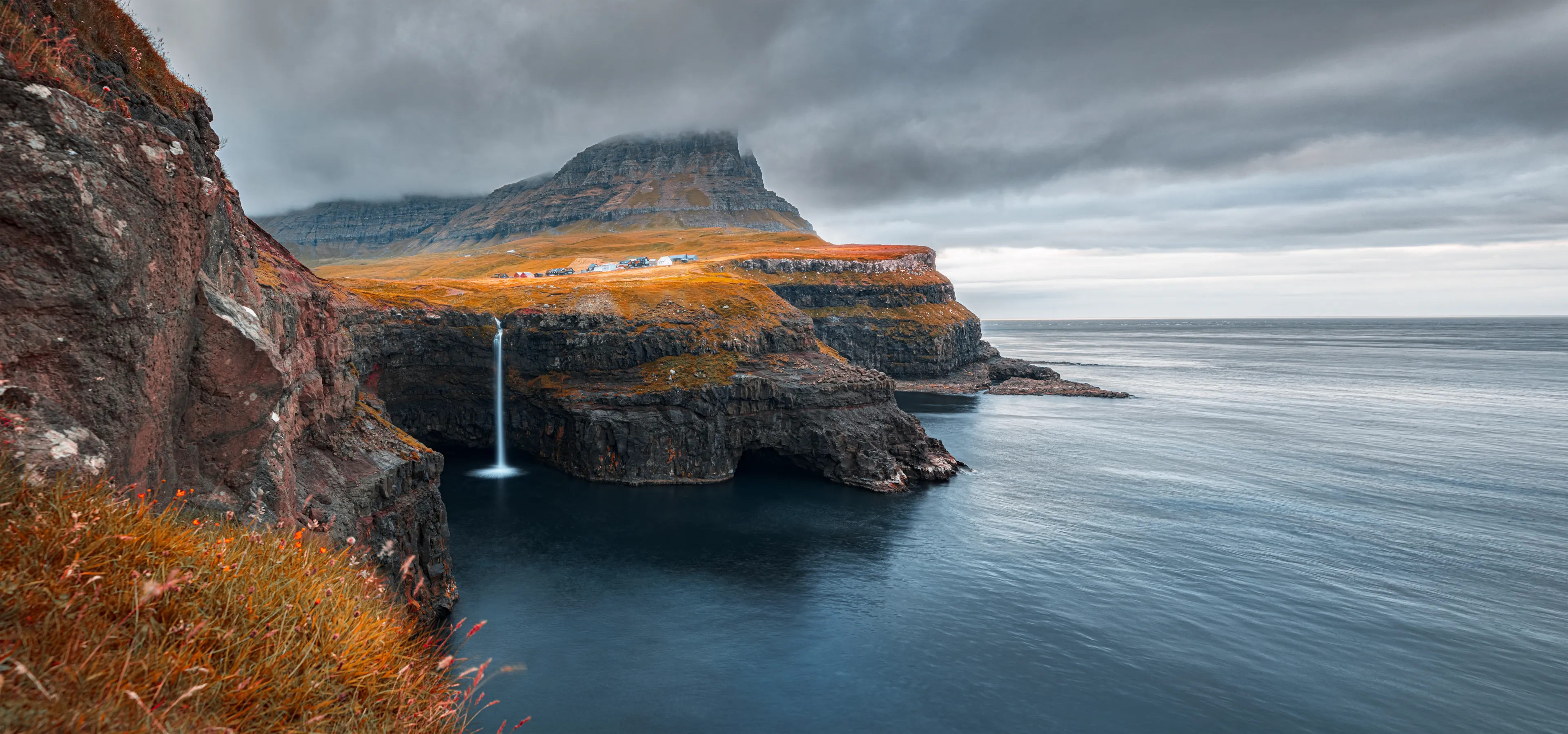 Incredible morning scene of Mulafossur Waterfall. Spectacular autumn view of Gasadalur village, Vagar, Faroe Islands, Denmark, Europe. Traveling concept background