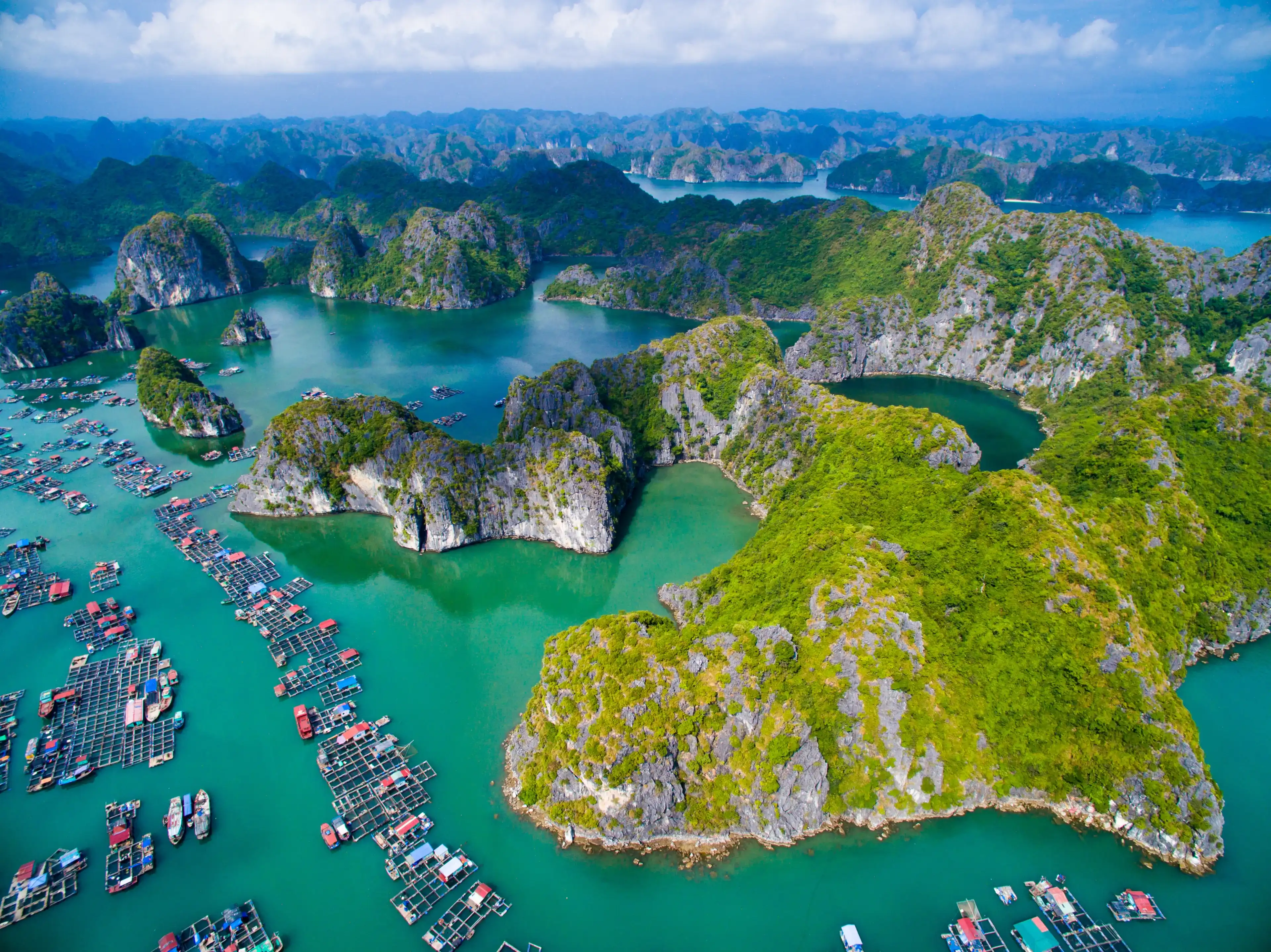 HAIPHONG, VIETNAM, November 8, 2015: Aerial view of floating villages around Cat Ba islands. Cat Ba is the largest of the 366 islands, which make up the southeastern edge of Ha Long Bay in Vietnam. HAIPHONG, VIETNAM, November 8, 2015: Aerial view of floating villages around Cat Ba islands. Cat Ba is the largest of the 366 islands, which make up the southeastern edge of Ha Long Bay in Vietnam.