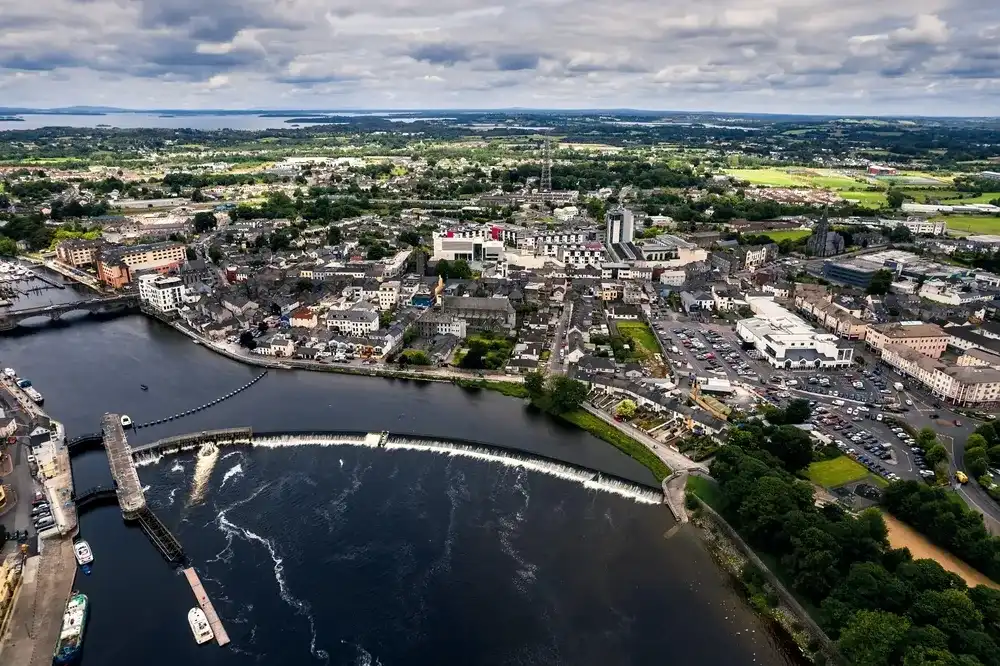 Athlone, Ireland - 07.14.2022: Aerial view on town center. Popular area with rich history and shopping centers and fine hotels and fine restaurants. Irish town. Athlone, Ireland - 07.14.2022: Aerial view on town center. Popular area with rich history and shopping centers and fine hotels and fine restaurants. Irish town.