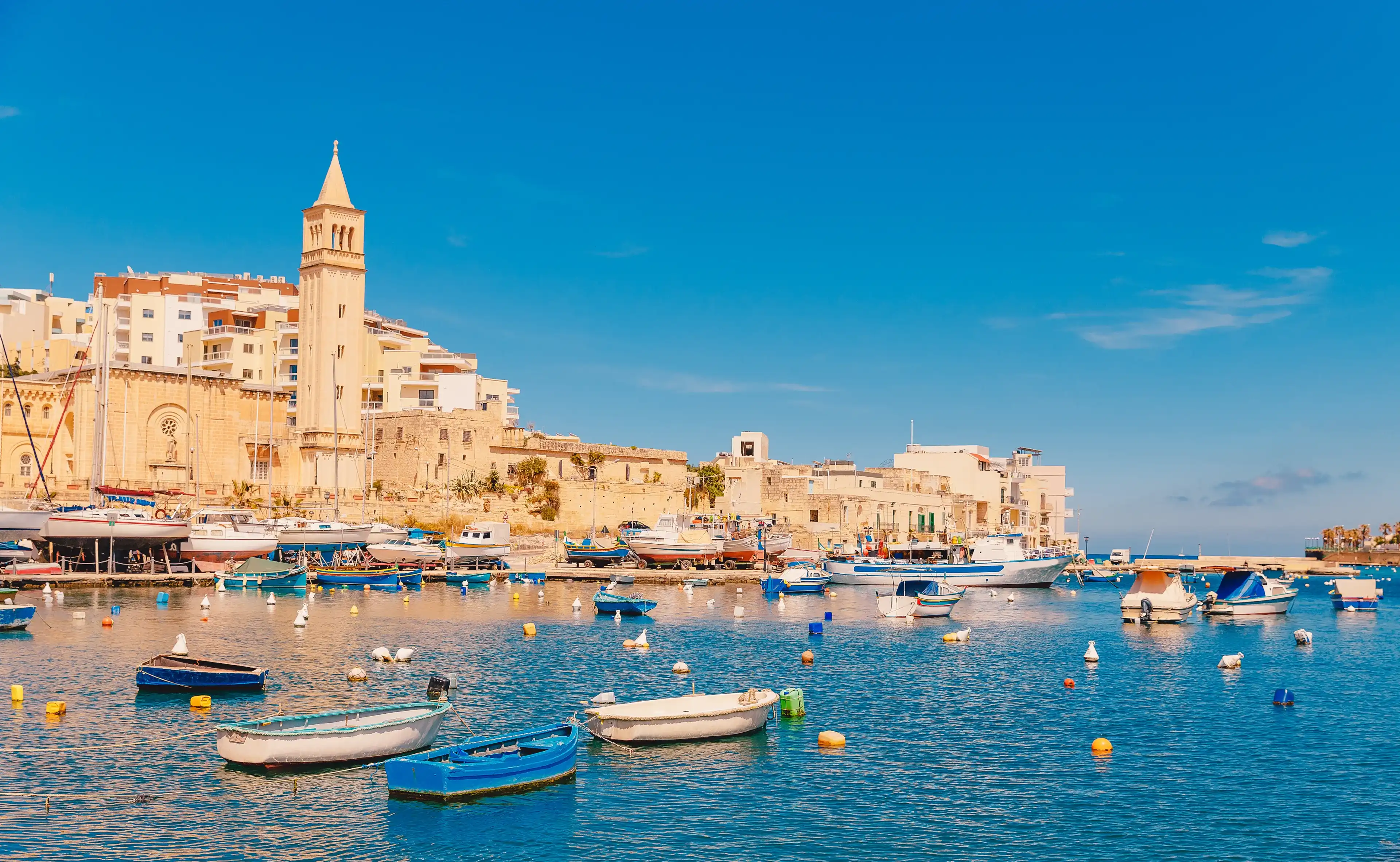 City Marsaskala Malta summer harbour Fishing boats in water mediterranean sea blue. City Marsaskala Malta summer harbour Fishing boats in water mediterranean sea blue.