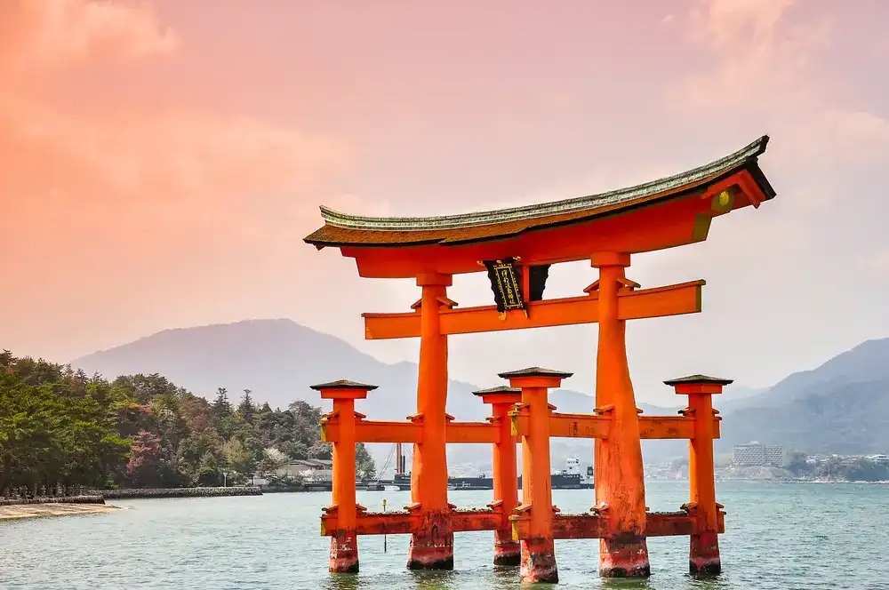 Miyajima, Hiroshima, Japan at the floating gate of Itsukushima Shrine. (gate sign reads Itsukushima Shrine) Miyajima, Hiroshima, Japan at the floating gate of Itsukushima Shrine. (gate sign reads Itsukushima Shrine)