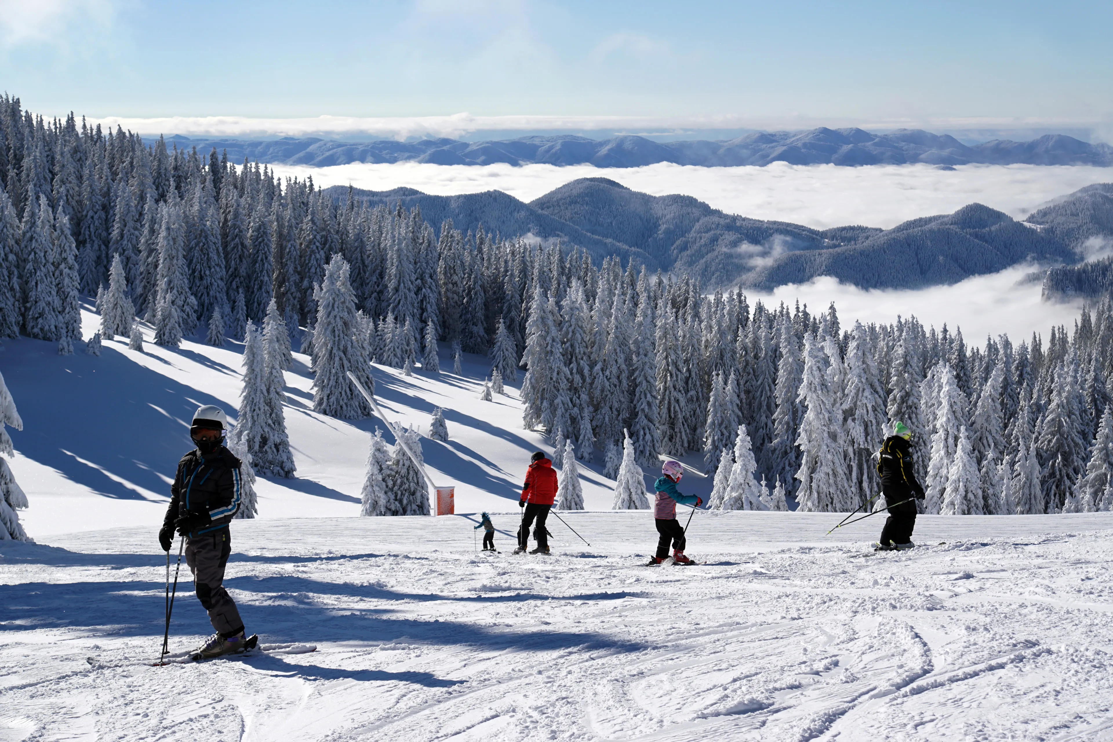 On the white slopes of Pamporovo, a ski resort in Bulgaria, skiing people