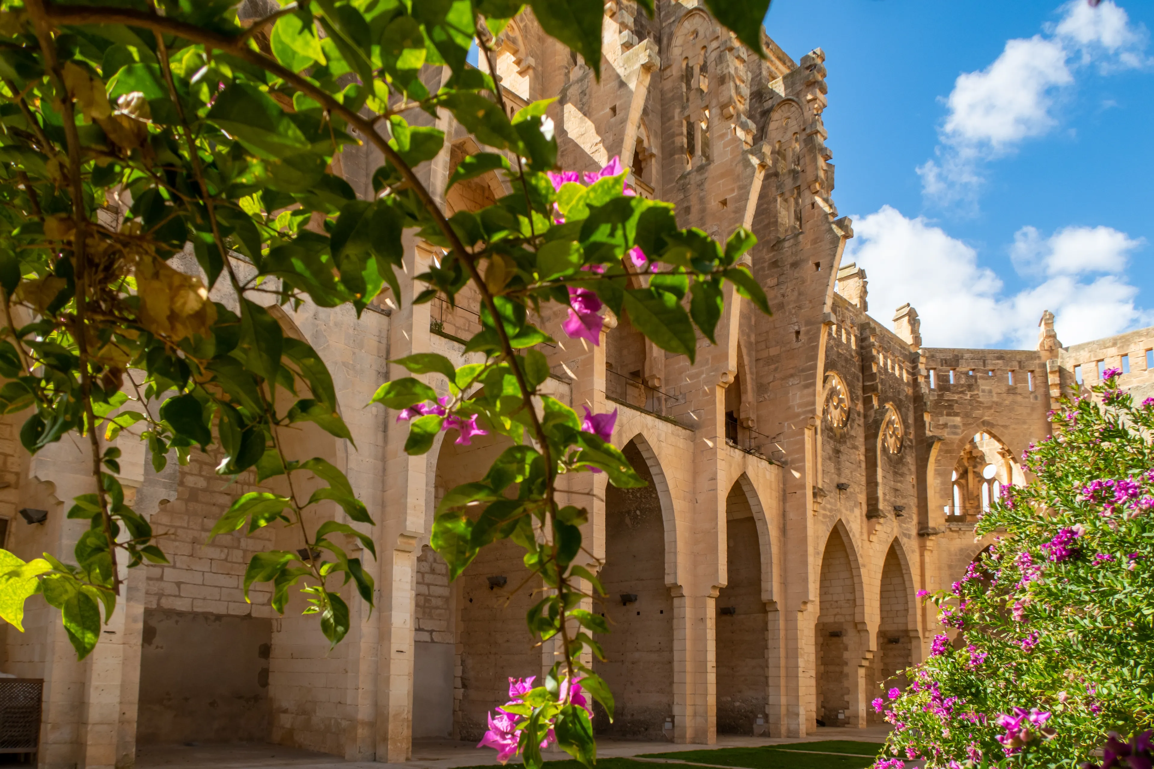 Walls of Iglesia Nova in Son Servera with bougainvillea flowers.