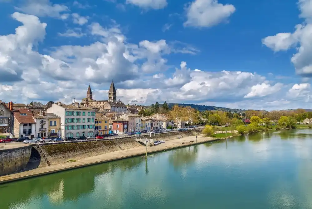 View of Tournus with abbey fron Saone river, France View of Tournus with abbey fron Saone river, France