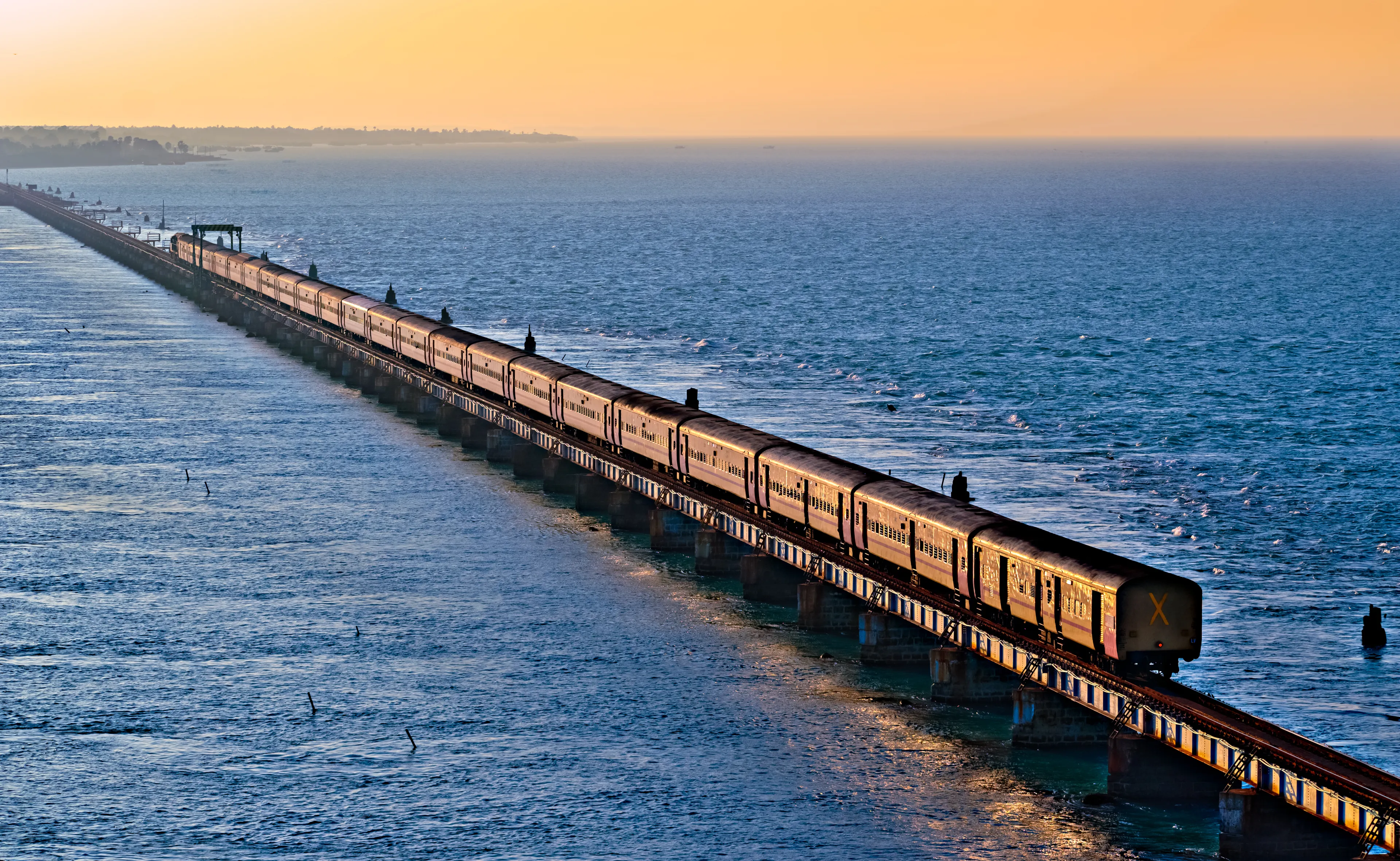 Ramaeswaram,Tamil Nadu, India-January 29th,2020: Evening golden sunlight reflects on the sides of Chennai bound Boat Mail express over Pamban bridge.