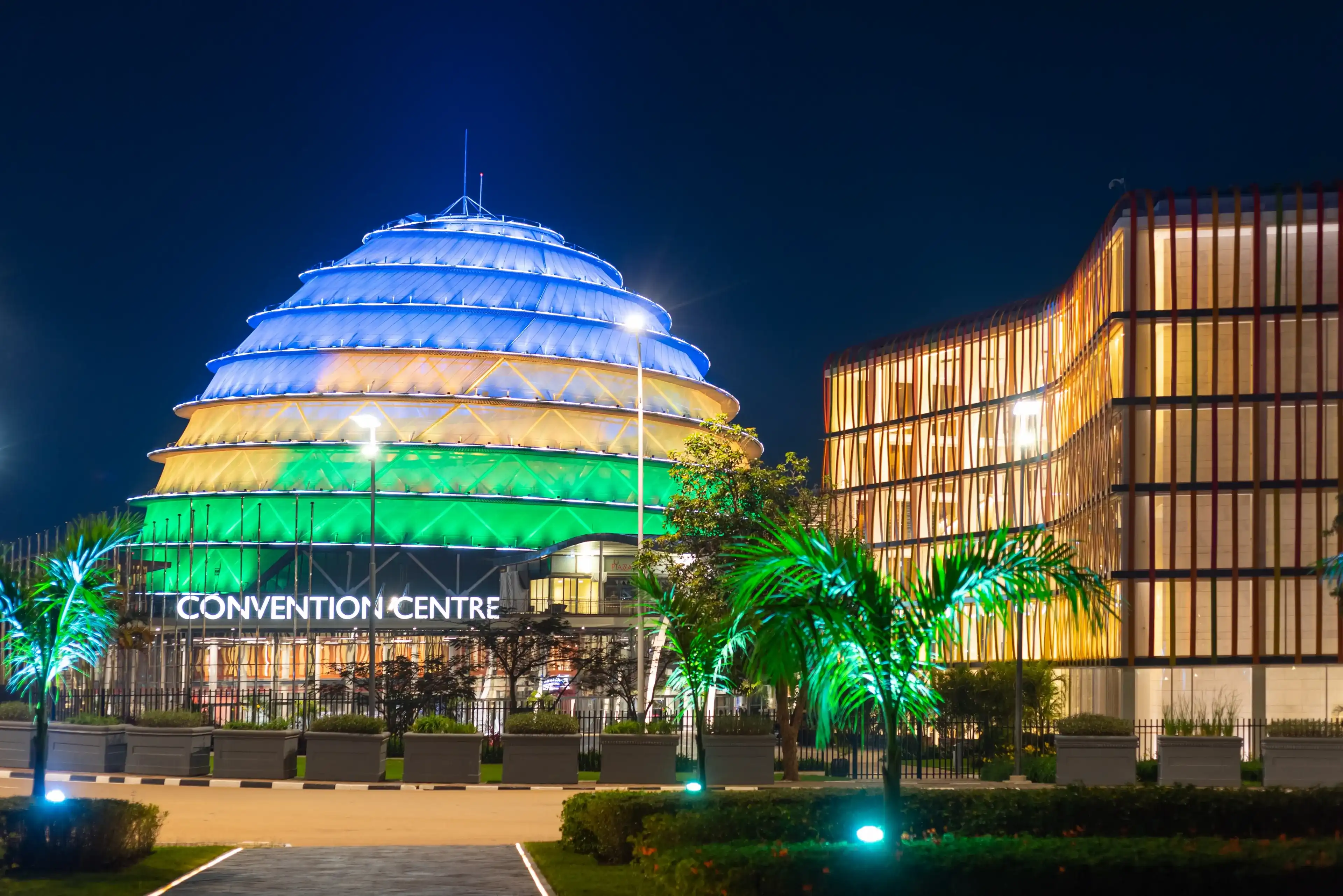 Kigali, Rwanda - August 19 2022: Kigali Convention Centre at night, lit up in the colors of the Rwandan flag. The facility is designed to host a variety of events and is a top attraction in the city. Kigali, Rwanda - August 19 2022: Kigali Convention Centre at night, lit up in the colors of the Rwandan flag. The facility is designed to host a variety of events and is a top attraction in the city.