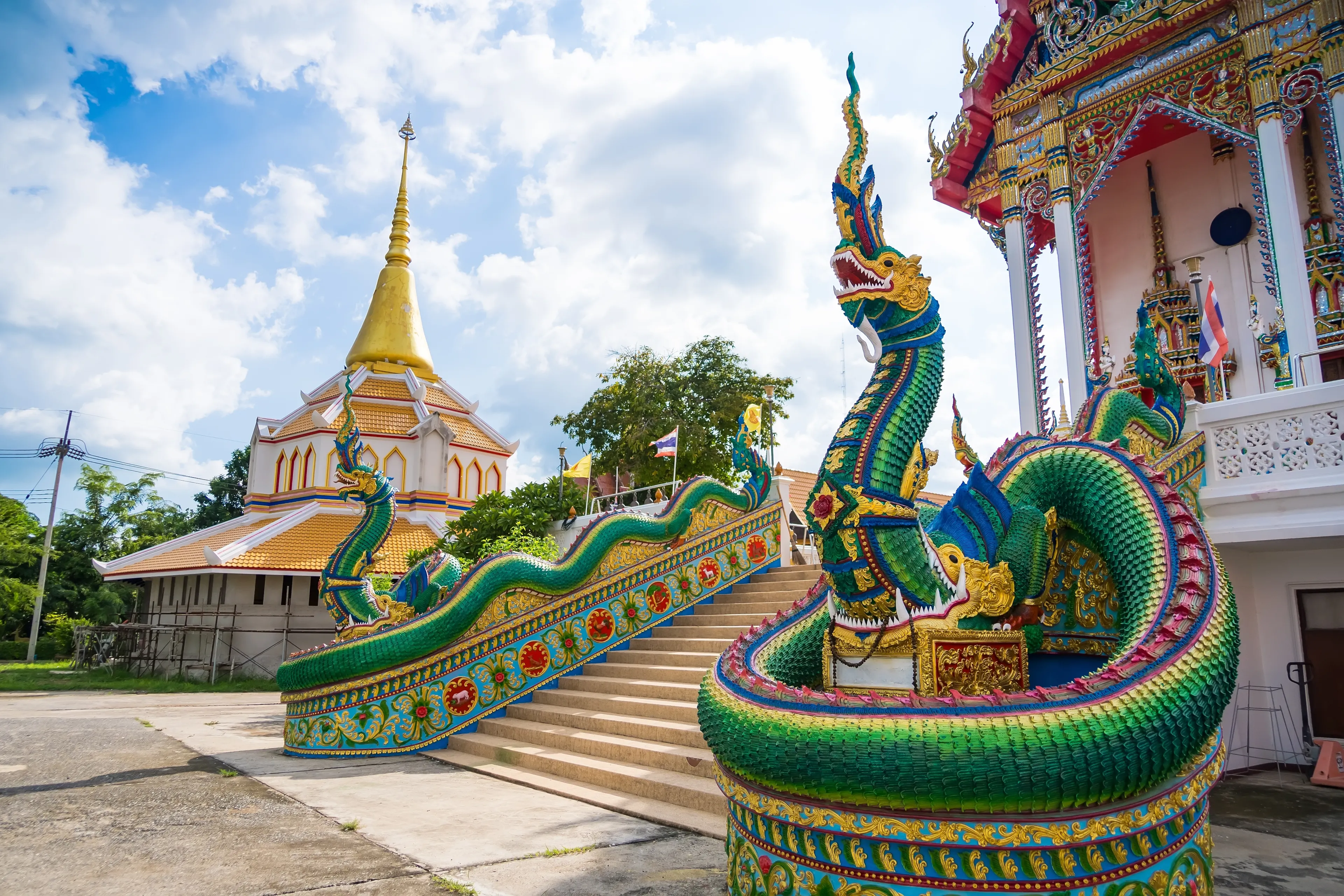 Lop Buri, Thailand - September, 20, 2024 :Vivid Naga Sculpture in Traditional Thai Temple Grounds at Lop Buri, Thailand.
