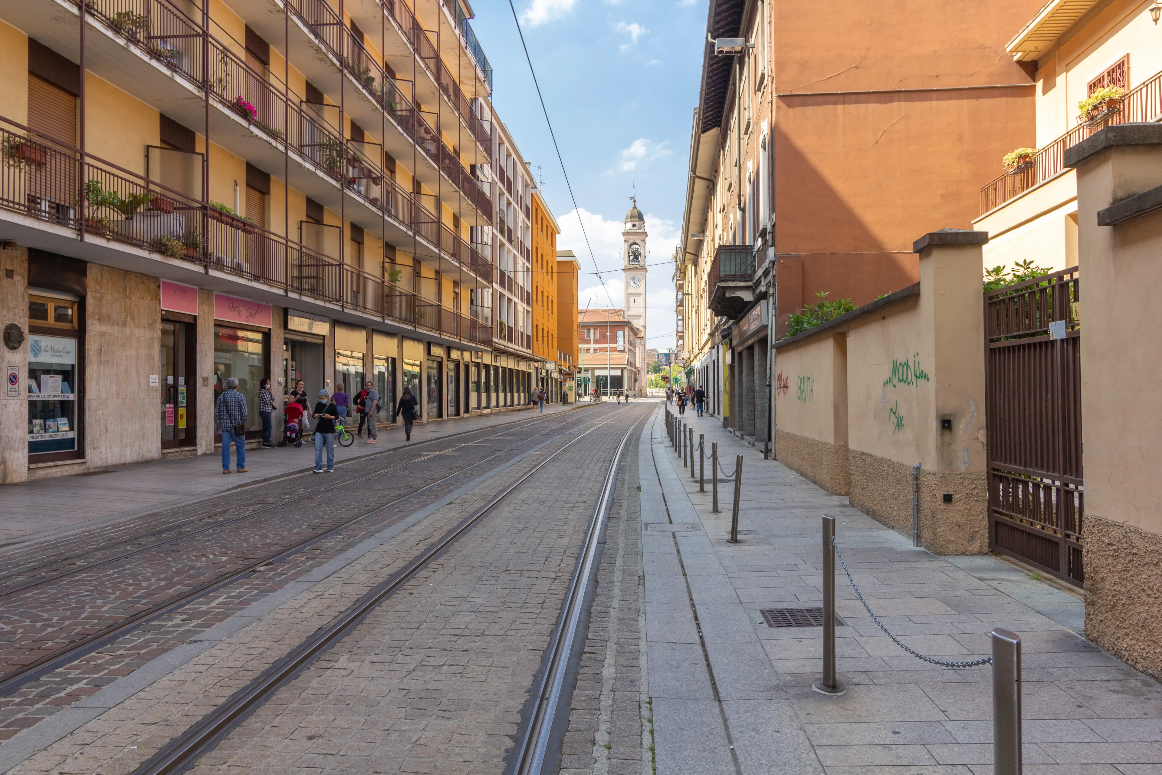 Cinisello Balsamo, Italy - May 28, 2021: Pedestrians wearing protective face masks along the city center, Cinisello Balsamo, Milan, Italy