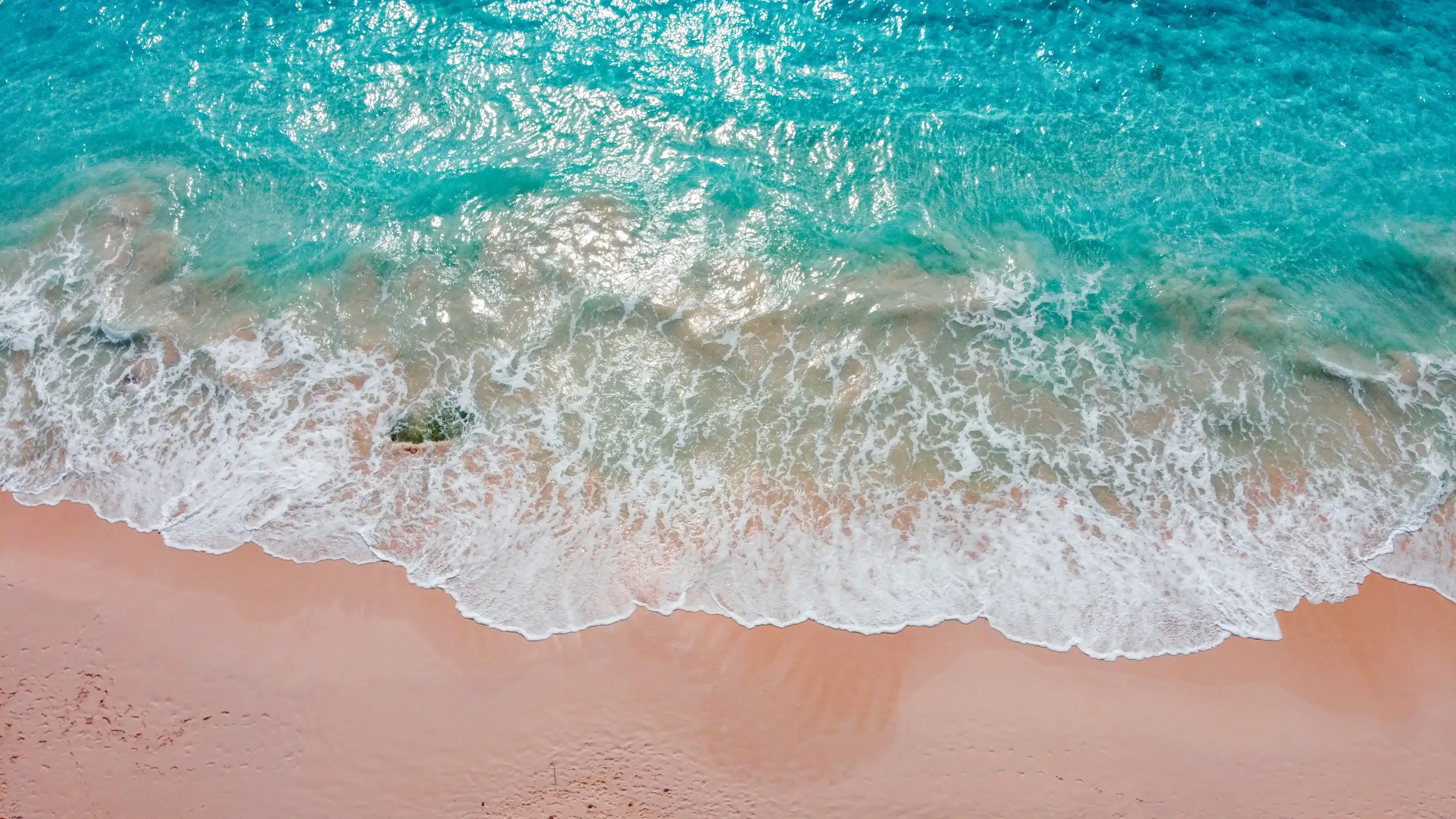 A scenic view with pink sands beach and blue ocean waves of Bermuda A scenic view with pink sands beach and blue ocean waves of Bermuda
