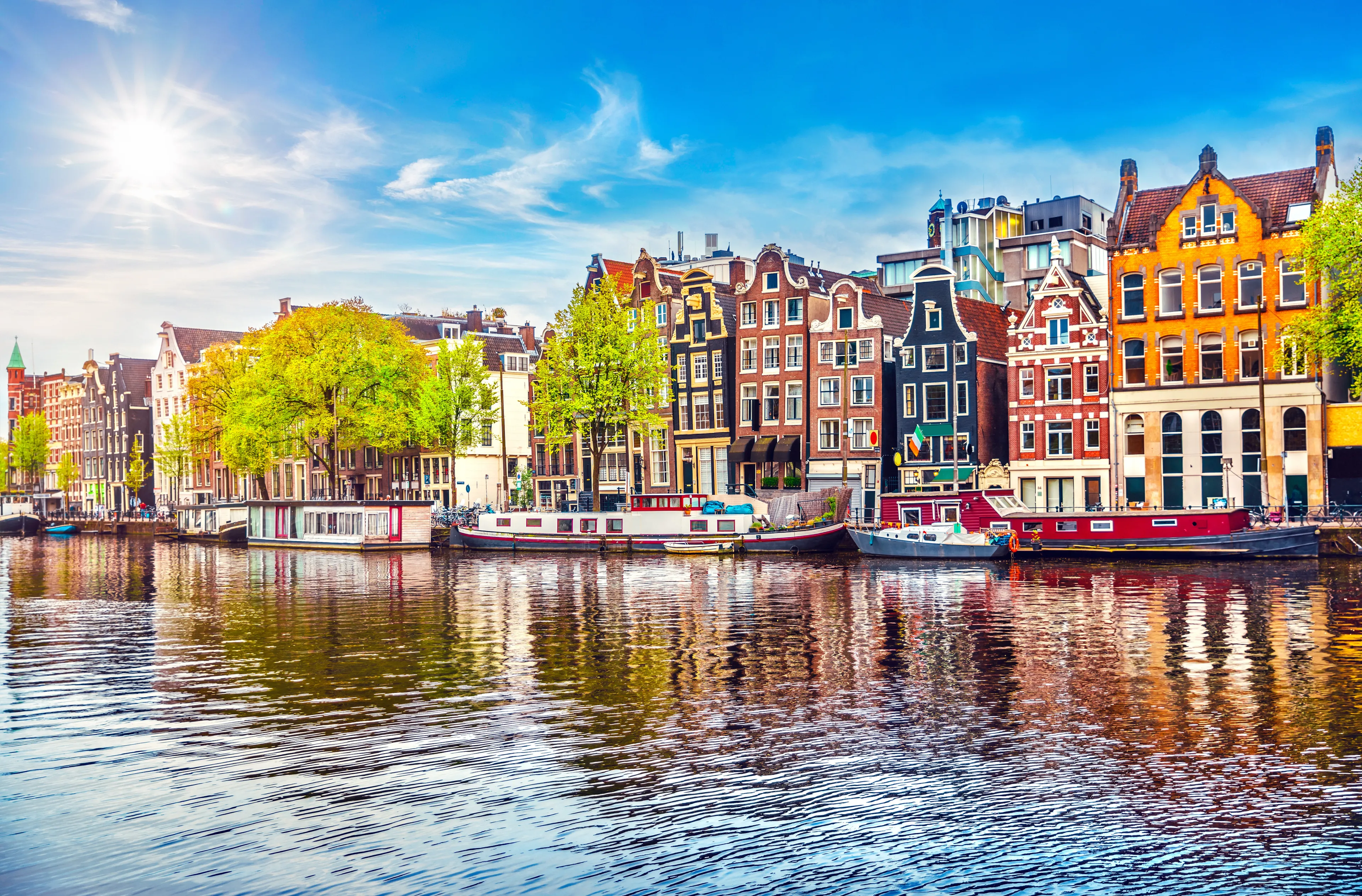 Amsterdam Netherlands dancing houses over river Amstel landmark in old european city spring landscape.