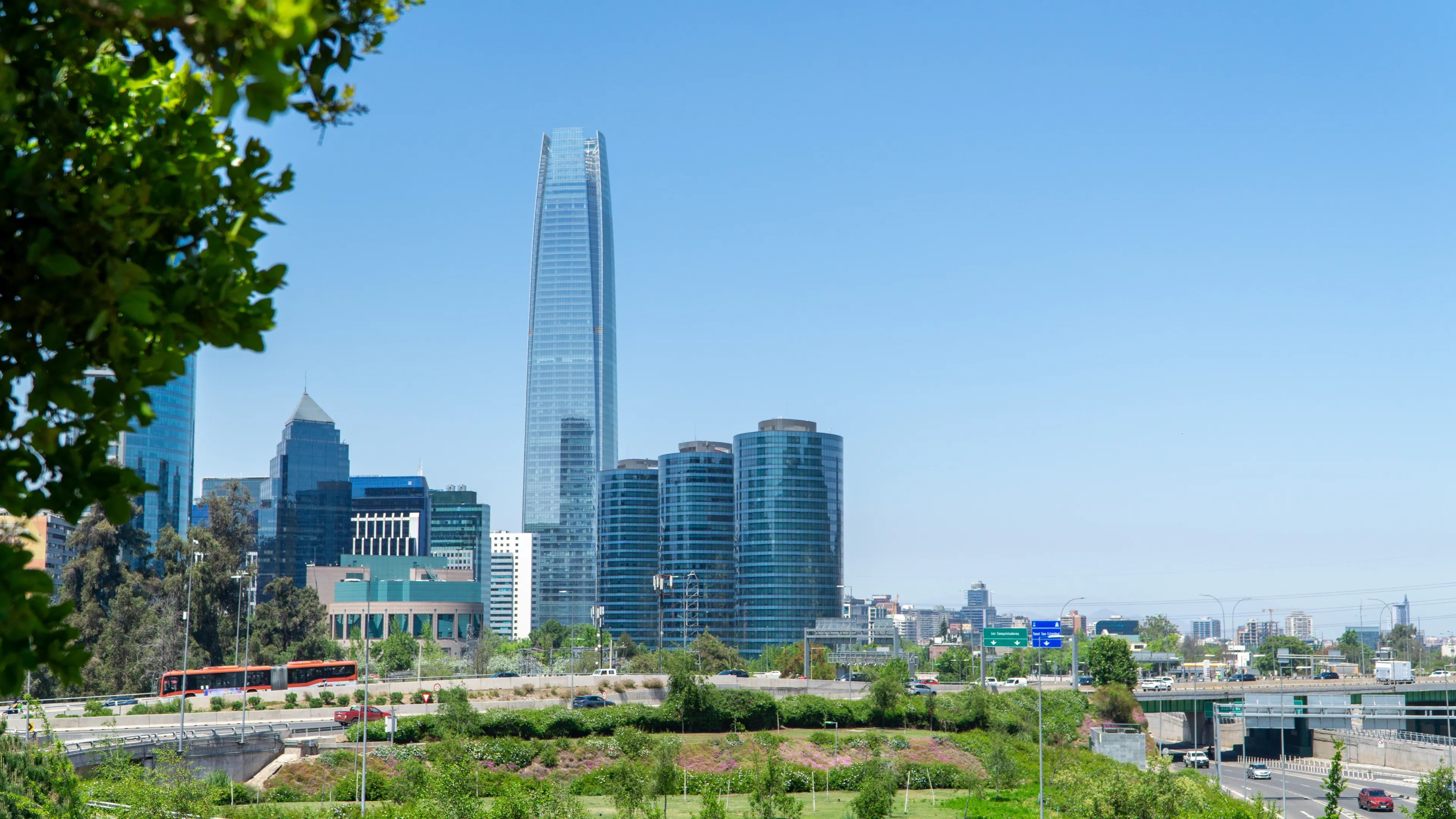Cityscape view of Santiago, Chile, featuring tall glass skyscrapers.