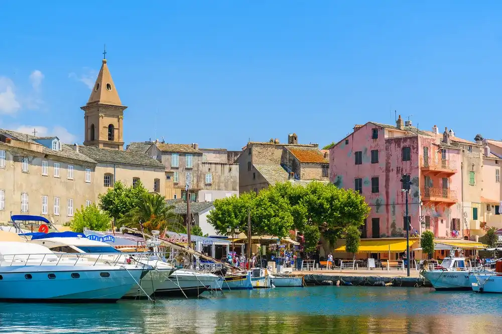 SAINT FLORENT, CORSICA ISLAND - JUN 30, 2015: a view of small port of Saint Florent with sailing boats, Corsica island, France. SAINT FLORENT, CORSICA ISLAND - JUN 30, 2015: a view of small port of Saint Florent with sailing boats, Corsica island, France.