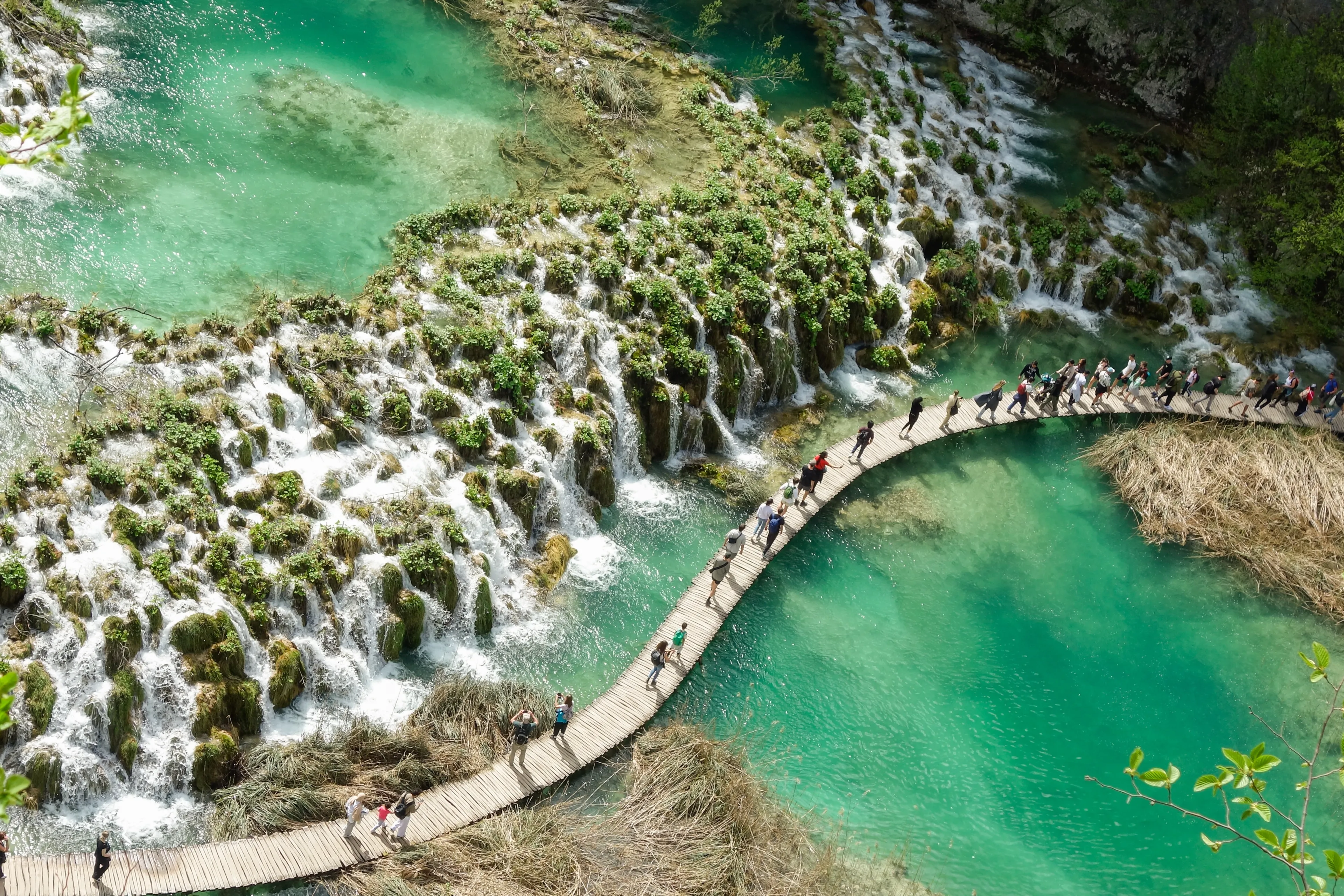Plitvicka Jezera, Croacia - 04.20.2025: tourists walking on wooden platform of Plitvice Lakes National Park.
