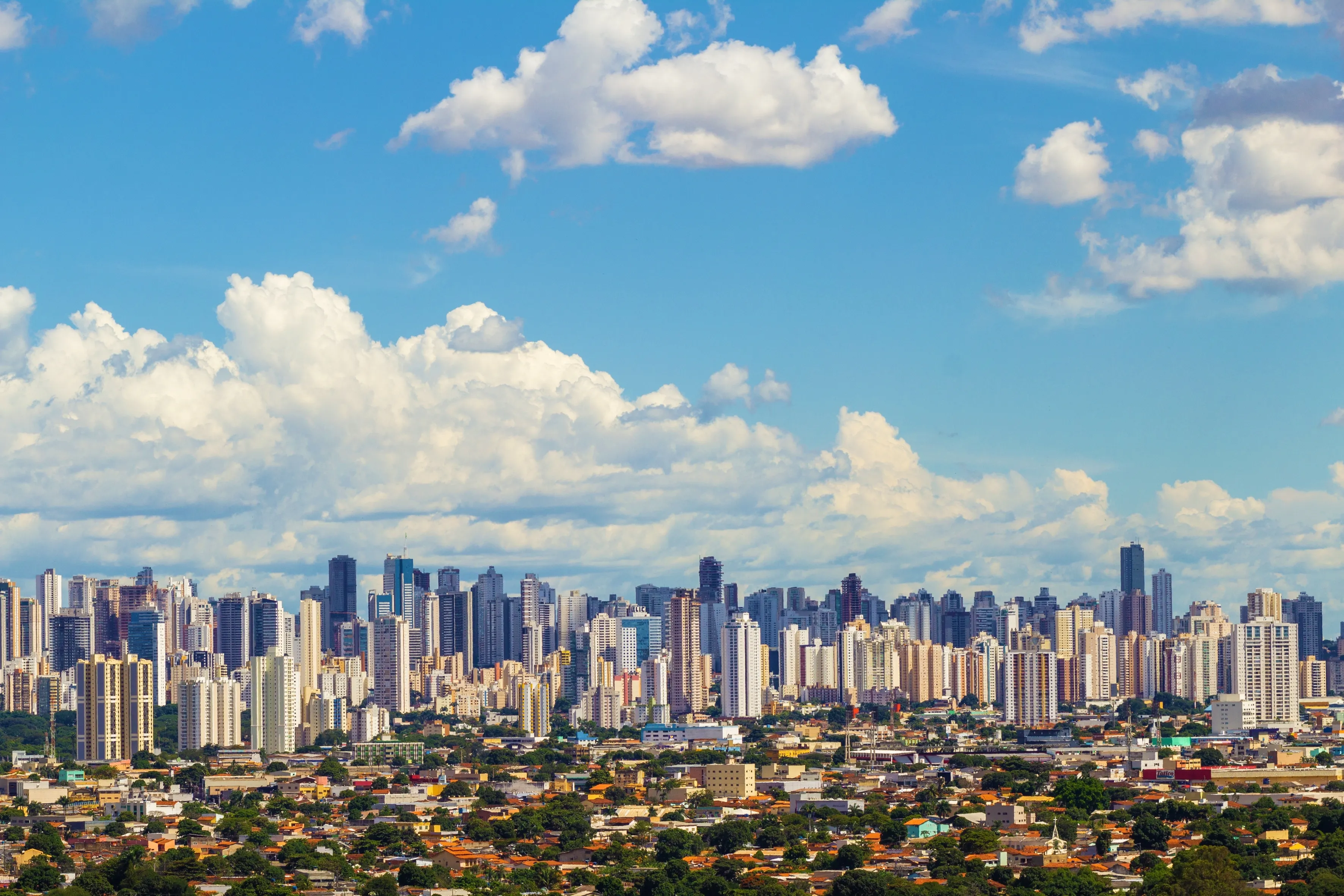 GOIÂNIA GOIAS BRAZIL – FEBRUARY 14 2023: City of Goiânia seen from Morro do Além, with many buildings and cloudy sky in the background.
