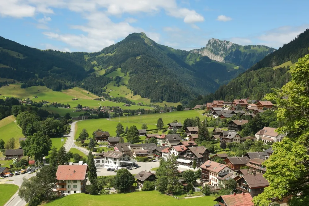 view of Château-d'Œx in Switzerland. Swiss village from above. Château-d'Œx from above surrounded by mountains. Château-d'Oex July 2024