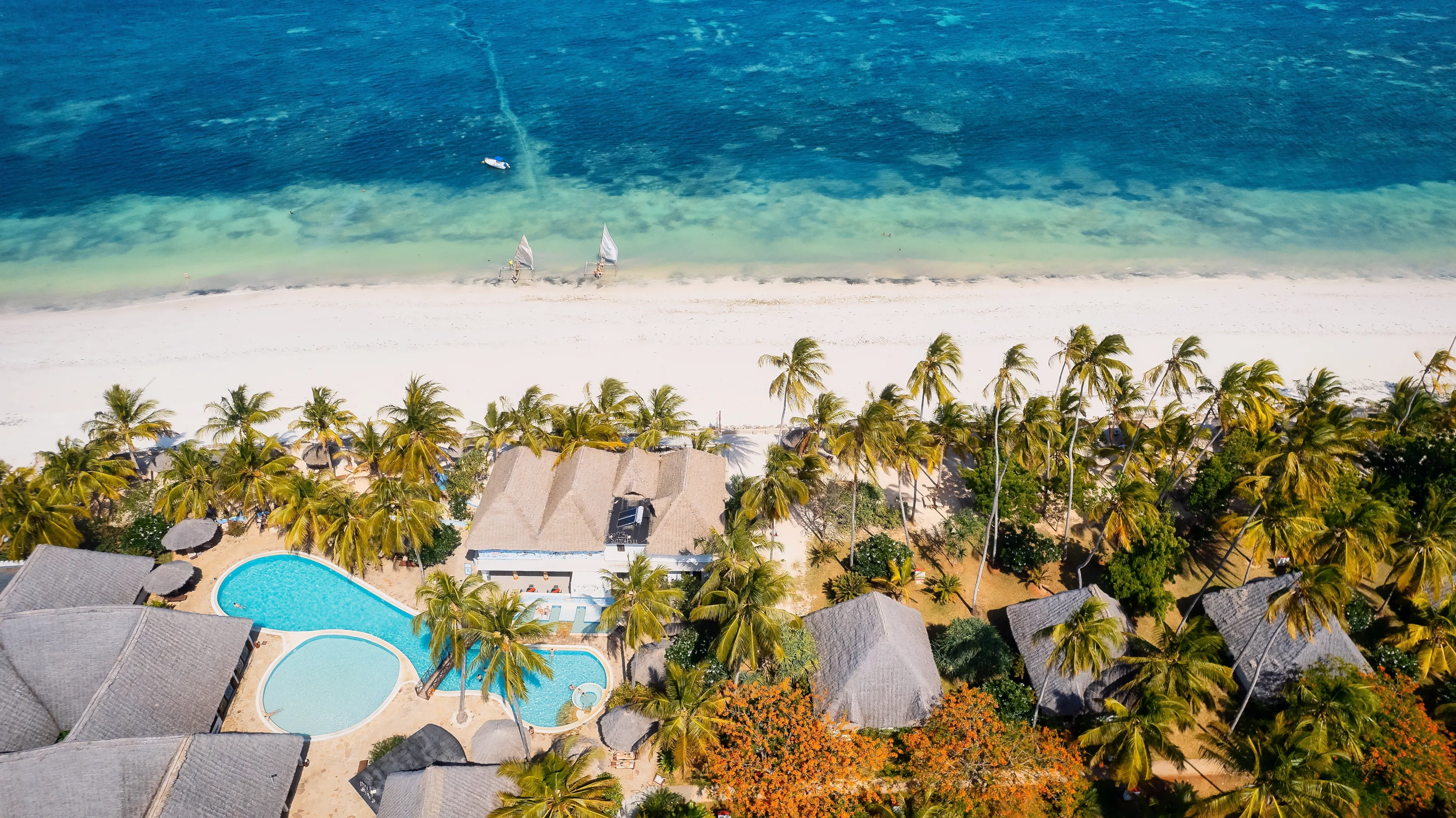 This stunning toned aerial view captures the beauty of Kiwengwa beach in Zanzibar, Tanzania. The luxurious resort and the turquoise ocean water create a picture-perfect scene.